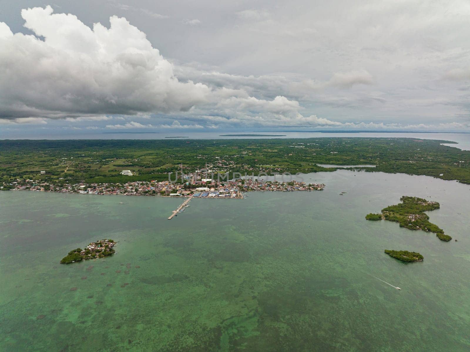 Aerial view of town on the seashore with a pier and fishermen's houses. Bantayan Island. Philippines.