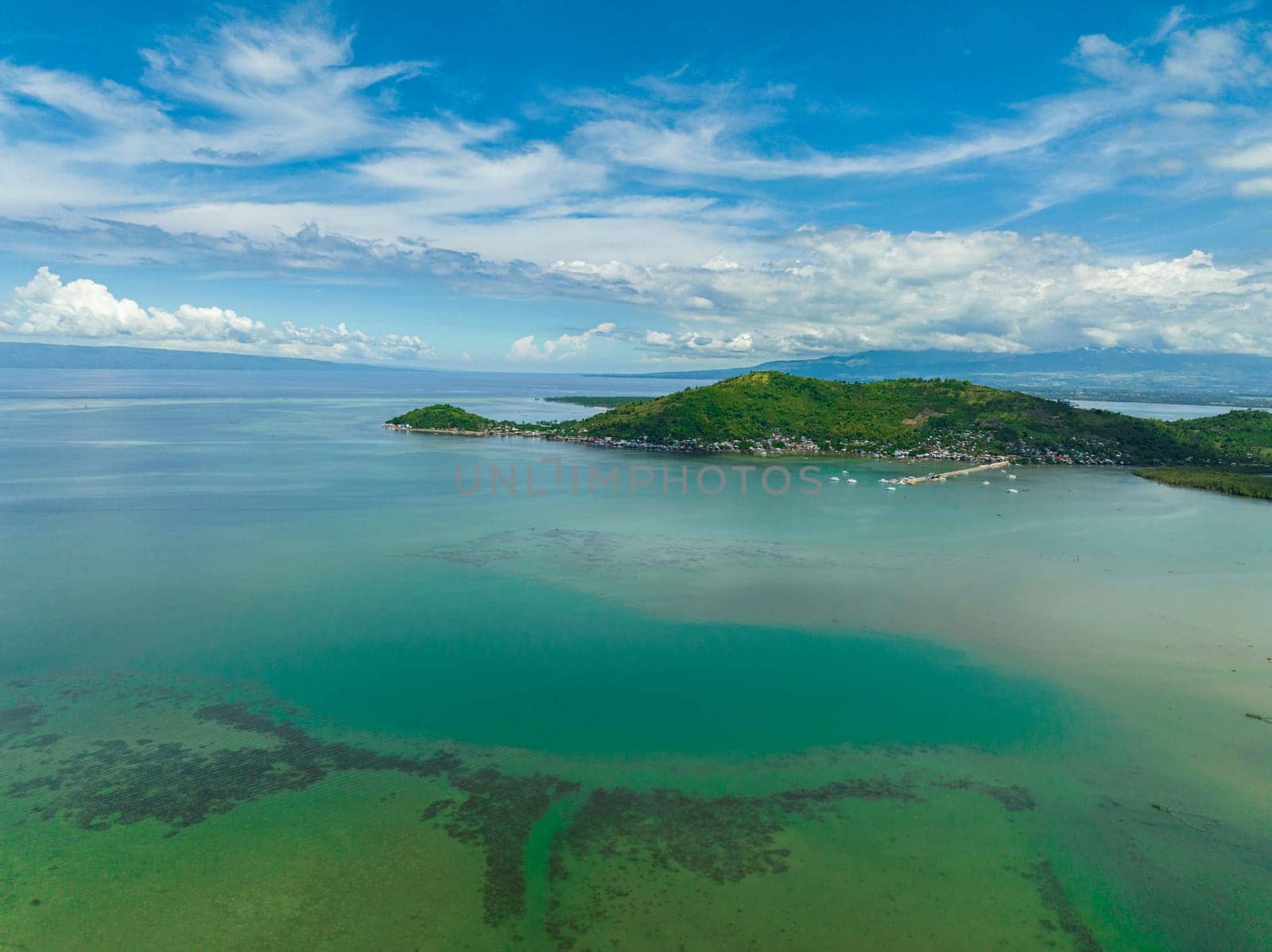 Top view of coast of Negros Island with farmland and town. Negros, Philippines.