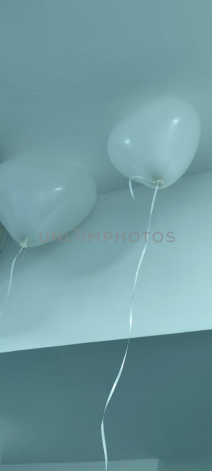 white heart shaped balloons hanging from ceiling, holiday objects. High quality photo