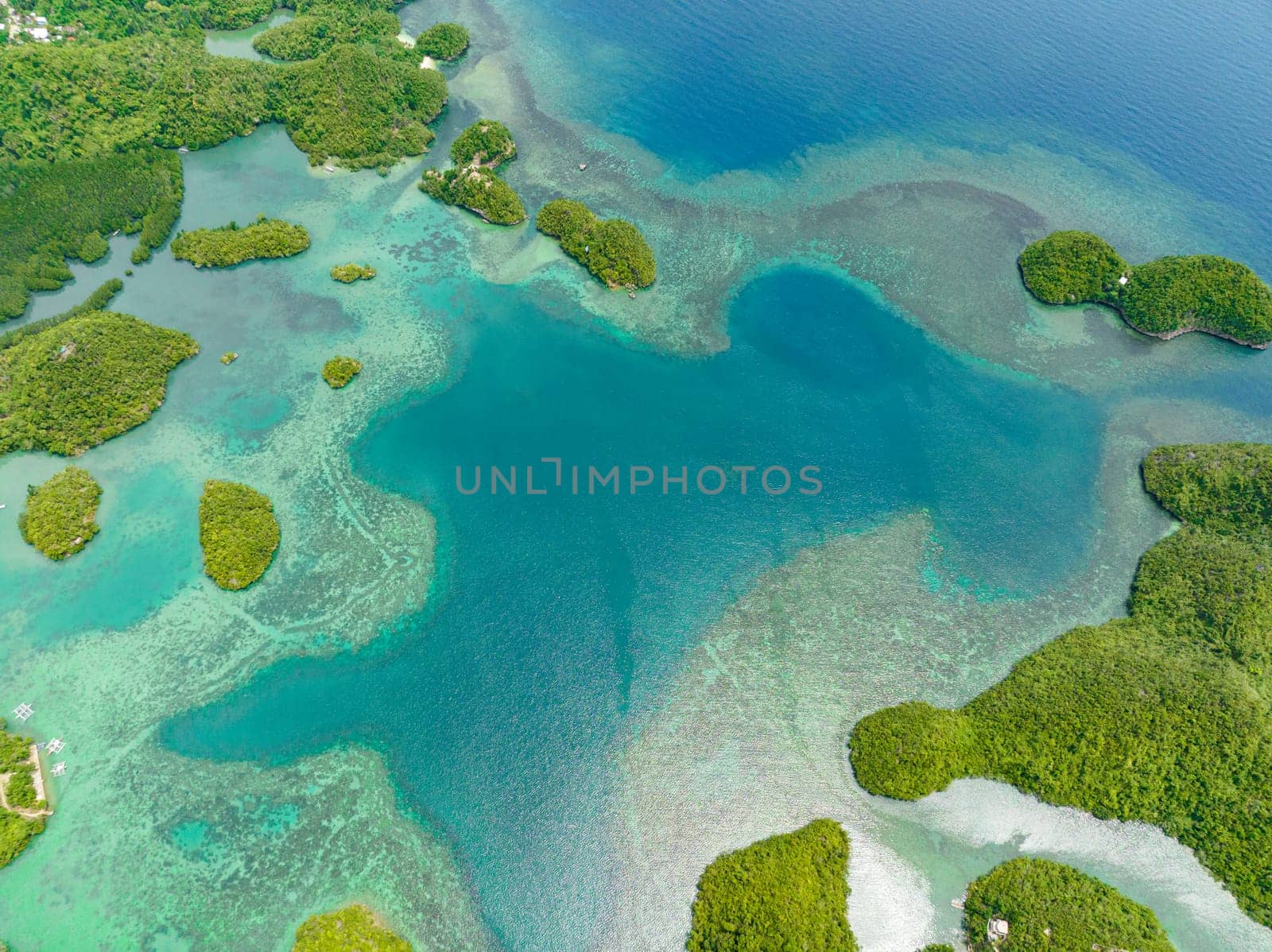 Aerial drone of tropical islands in a beautiful bay with turquoise water and lagoon. Sipalay, Negros, Philippines.
