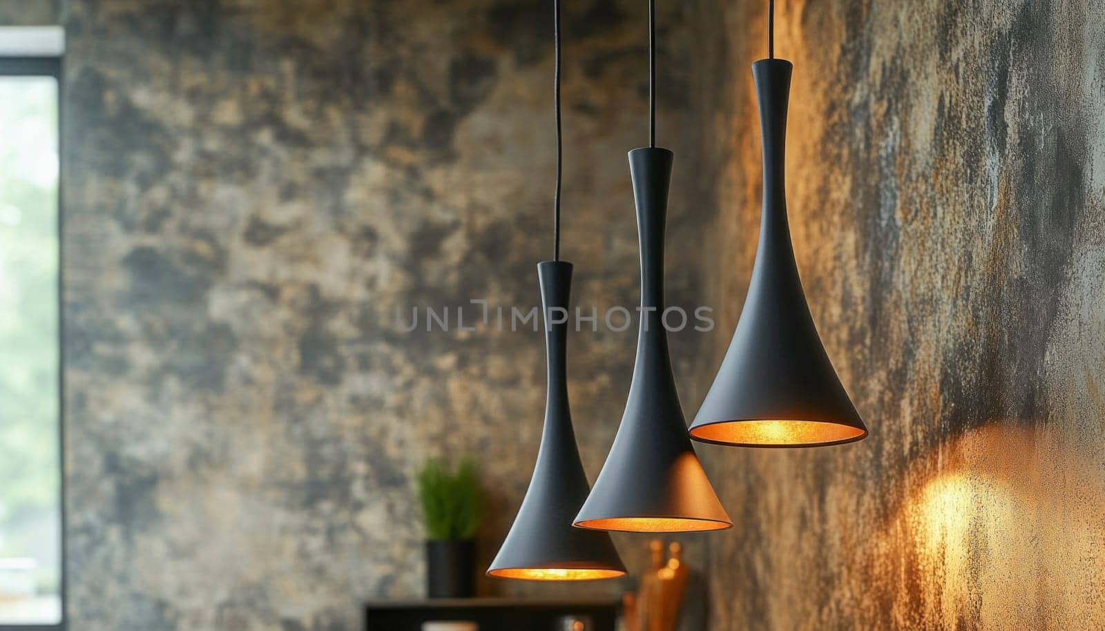 Stylish black pendant lamps illuminating a modern interior with a textured concrete wall, creating a warm and inviting atmosphere