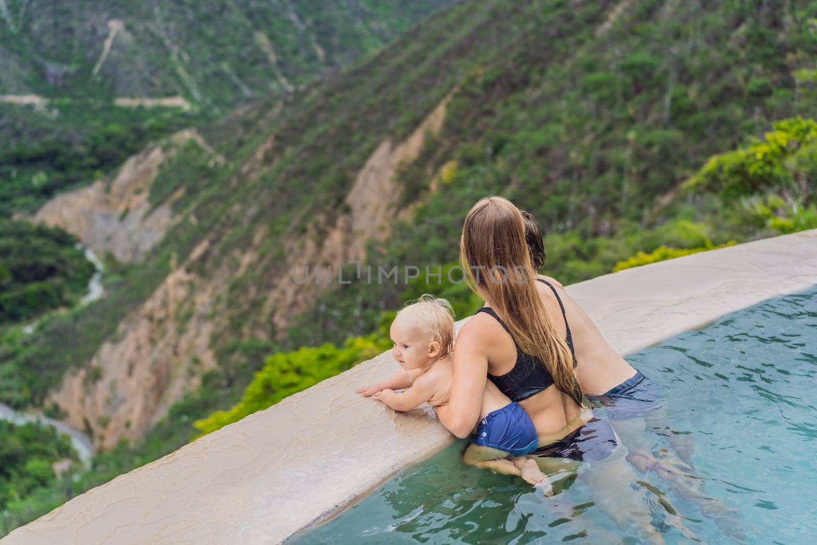 Mother with her toddler and teenage sons bathing in the hot springs of Grutas Tolantongo, Mexico. Family adventure, relaxation, and natural wellness concept.