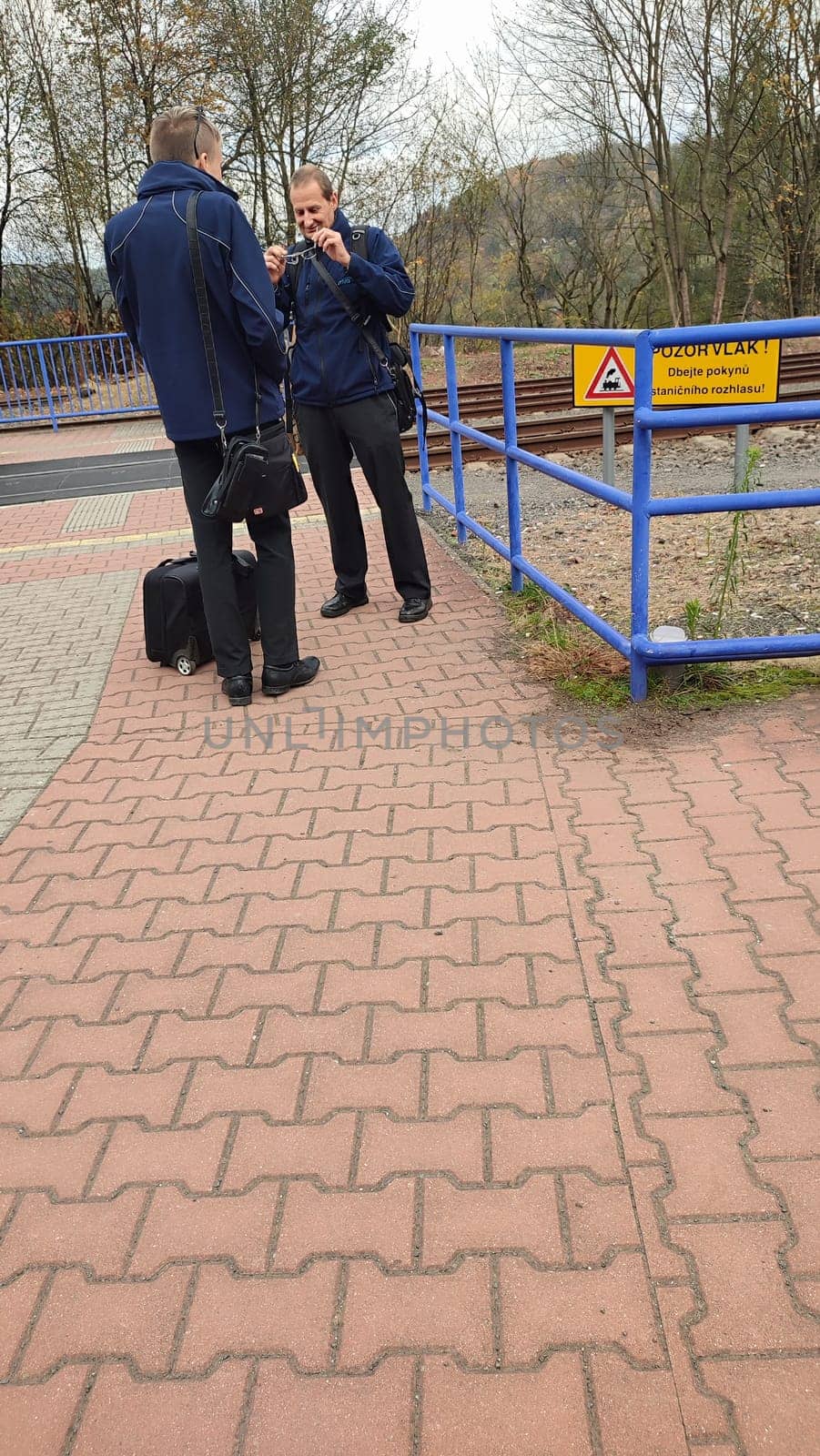 October 21 2024 Stara Paka, Czech Republic, two men in jackets talking on the street. High quality photo