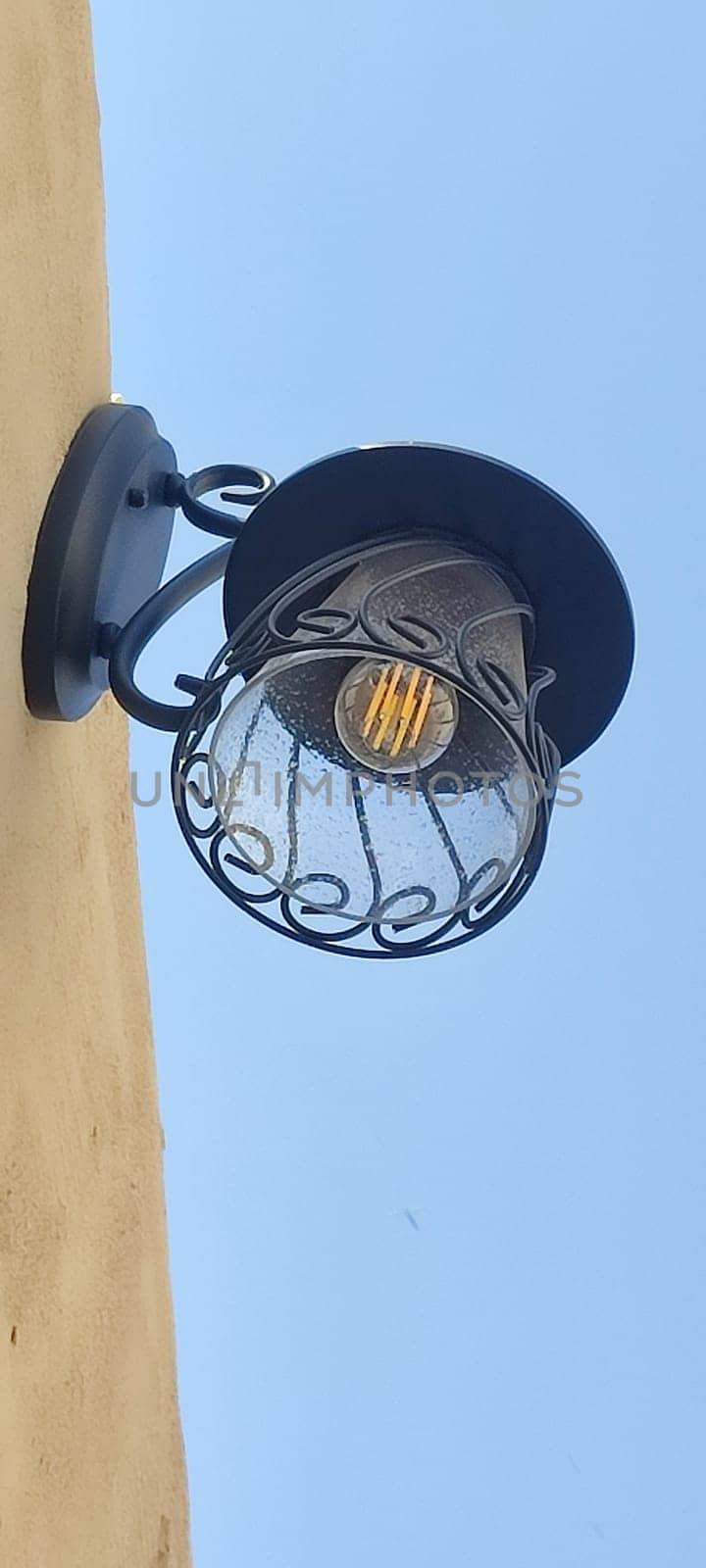 lamp lantern hanging on wall blue sky object electricity. High quality photo