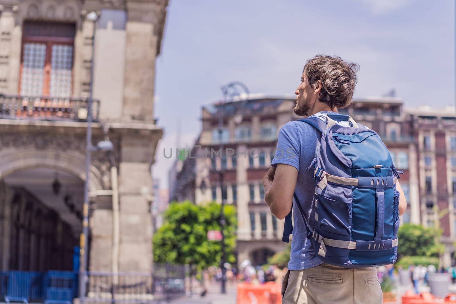Male tourist in the central square of Mexico City, Zocalo. Cultural exploration, travel, and historic architecture concept.
