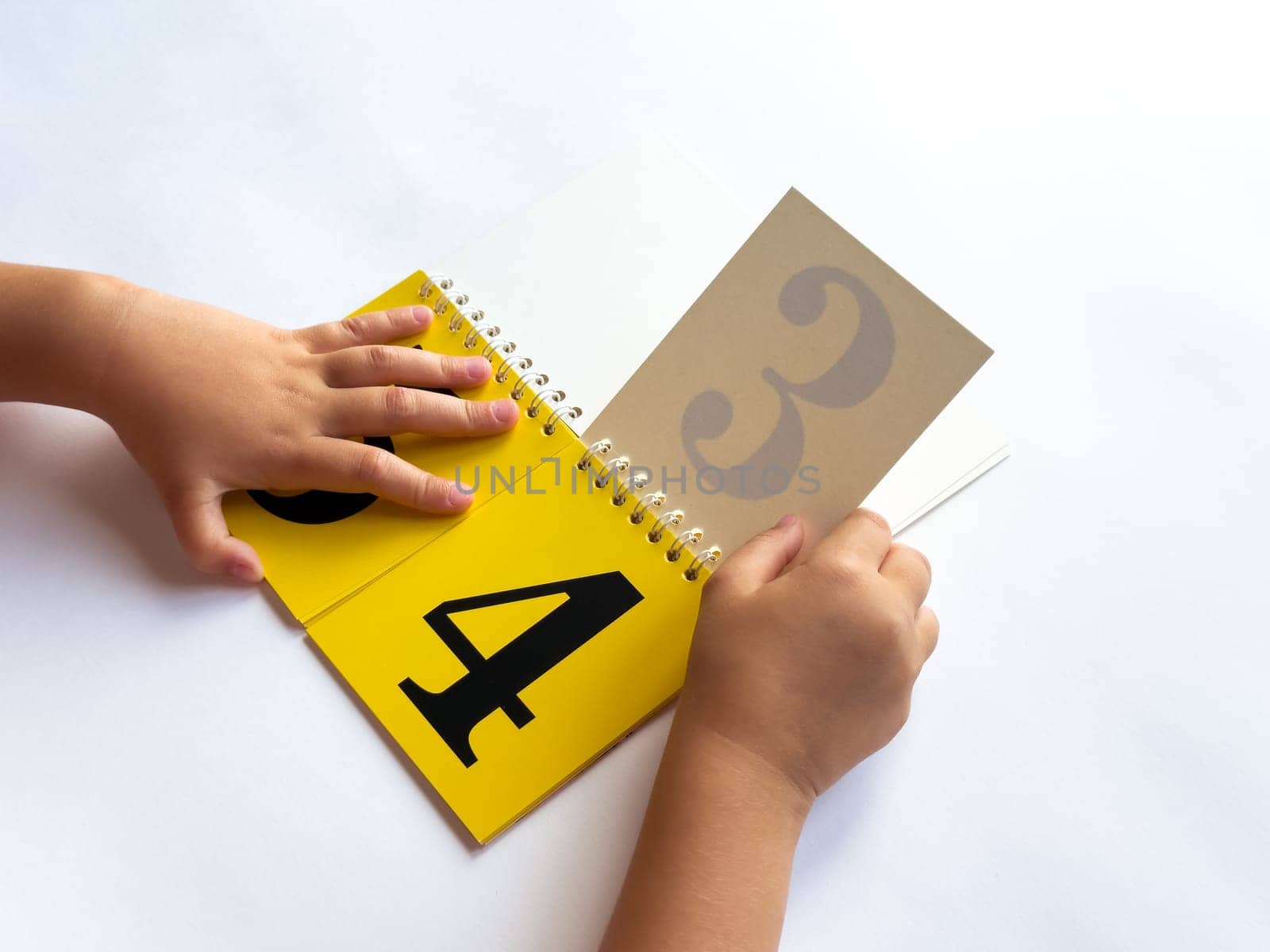 Child learning numbers with a colorful educational flip book.