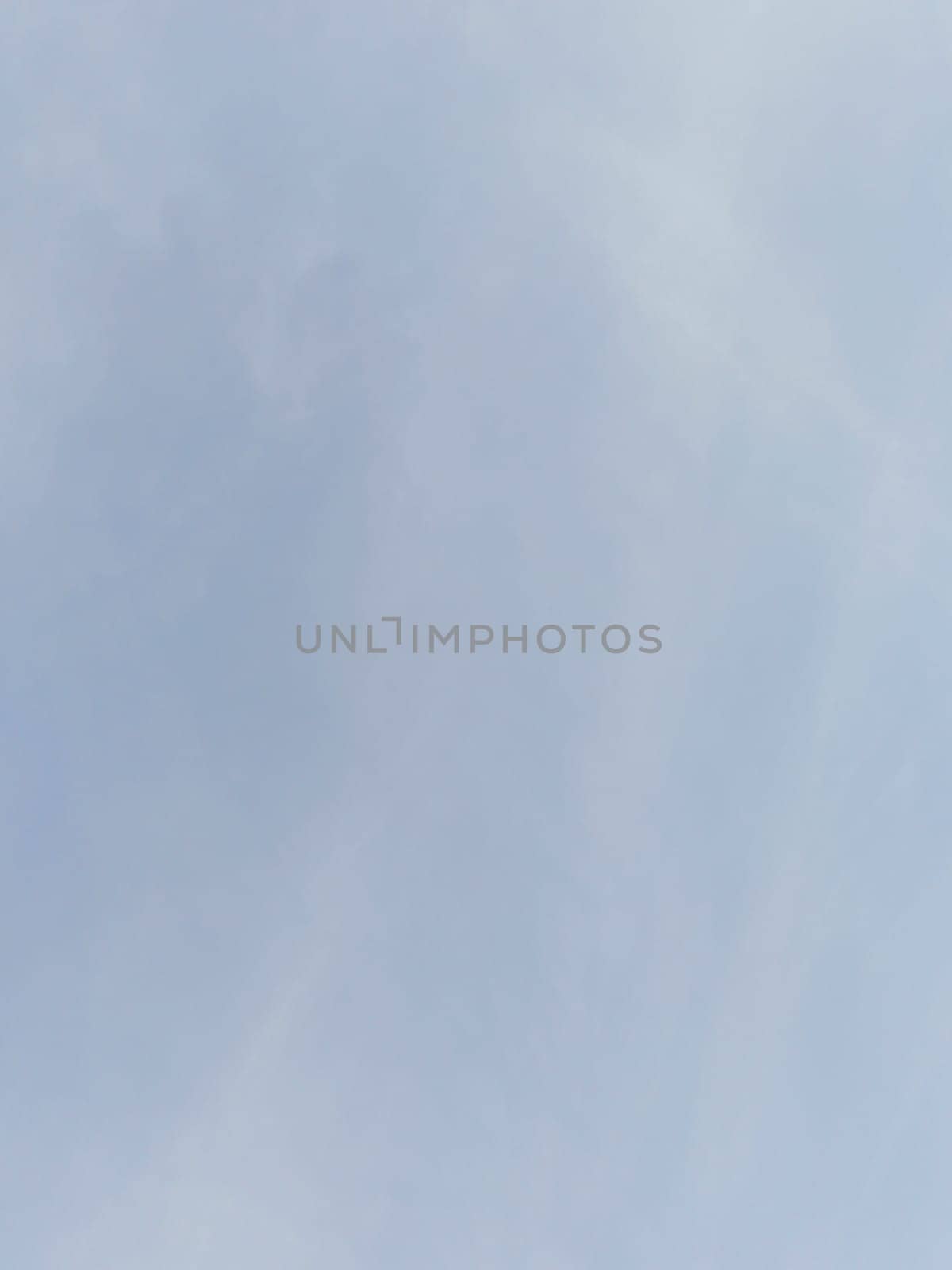Serene image of a clear blue sky with soft clouds offers a tranquil and calming backdrop. Ideal for peaceful, nature-related themes and emphasizes simplicity and spaciousness.