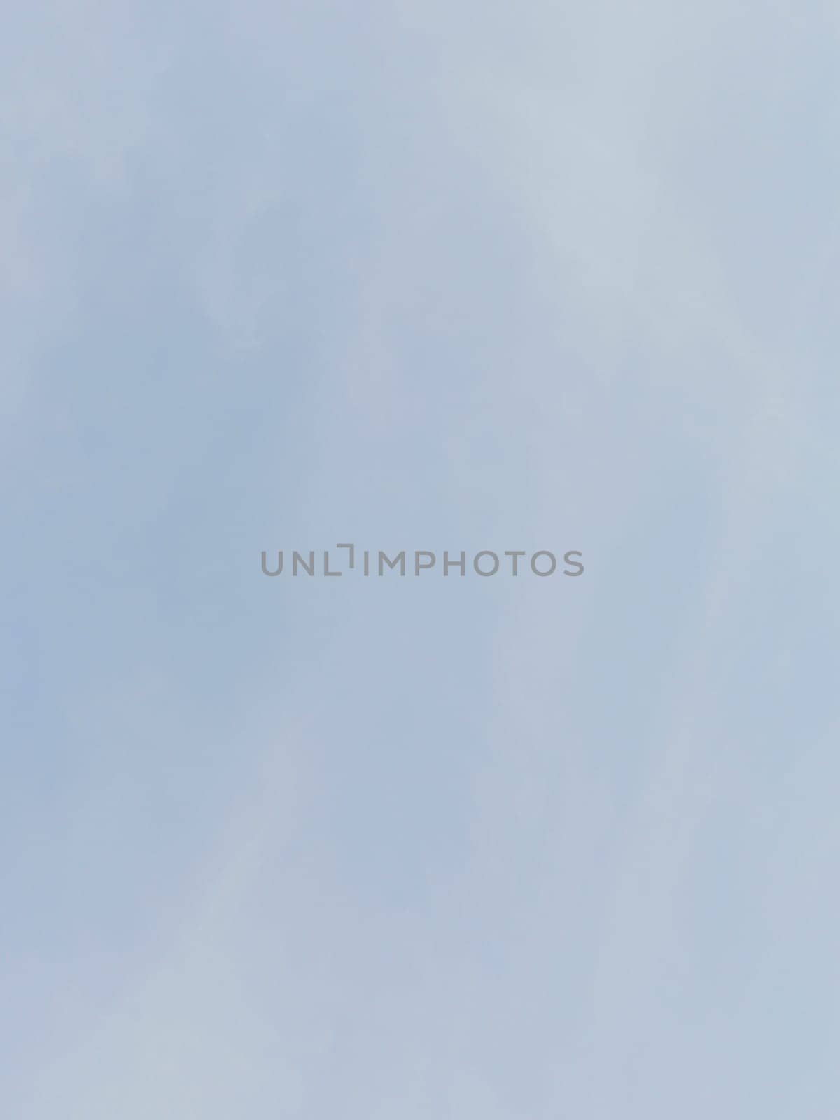 Serene image of a clear blue sky with soft clouds offers a tranquil and calming backdrop. Ideal for peaceful, nature-related themes and emphasizes simplicity and spaciousness.