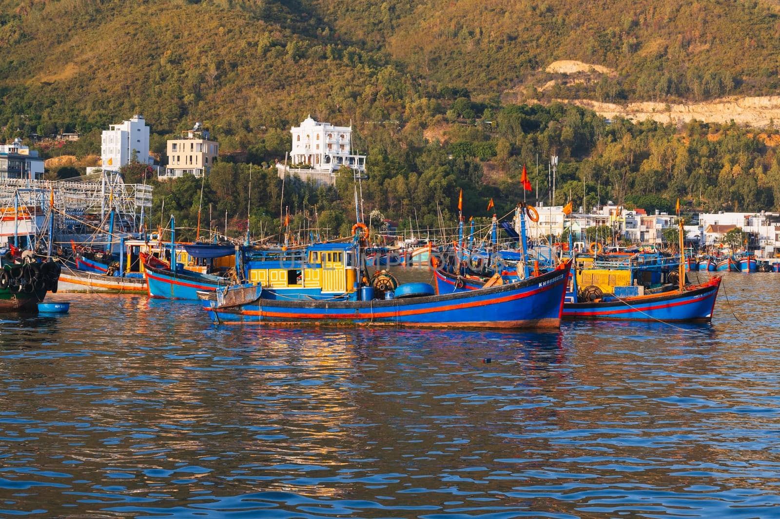Vietnamese fishing boats and ships in harbor at sea at the fishing port in Nha Trang in Vietnam. Nha Trang, Vietnam - September 8, 2024