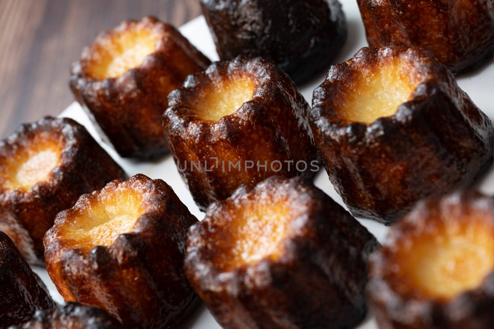 Caneles de bordeaux, traditional French sweet dessert with white table background, High quality photo