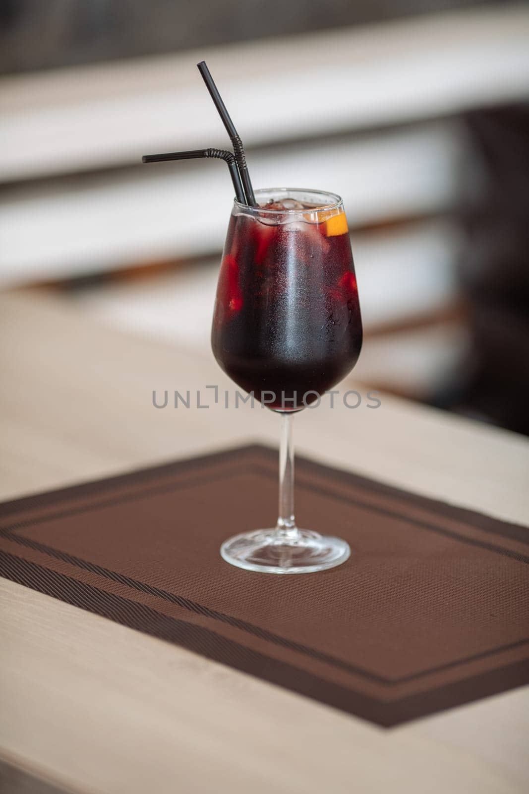 A glass of fresh delicious sangria on the table in the restaurant.