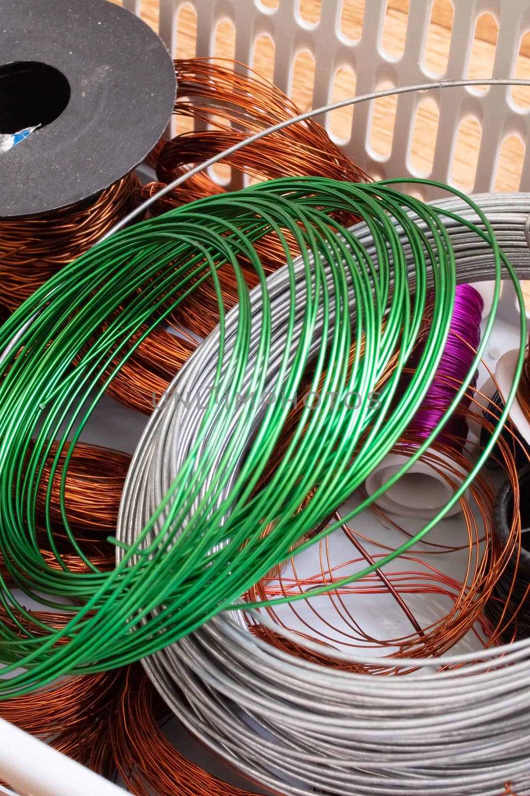 Copper wire coils in a plastic basket close up