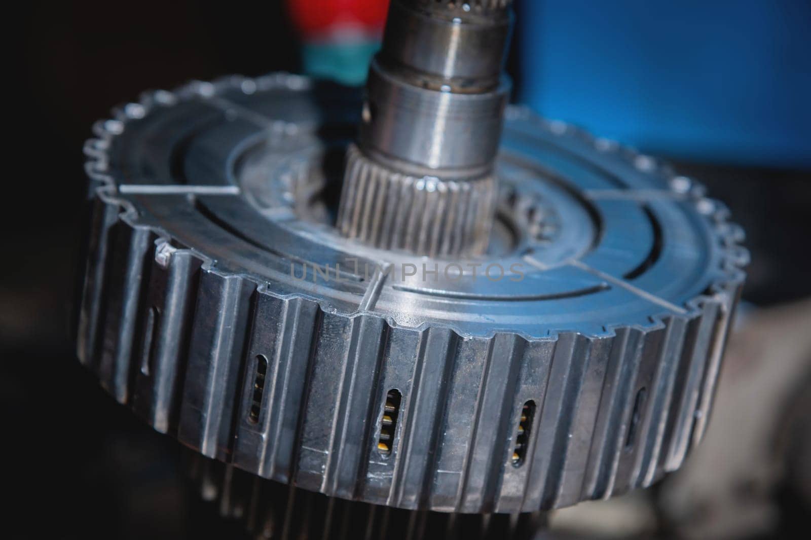 A close-up of a pack of clutches on a shaft with a gear from an automatic transfer case of a four-wheel drive car. Toned image..