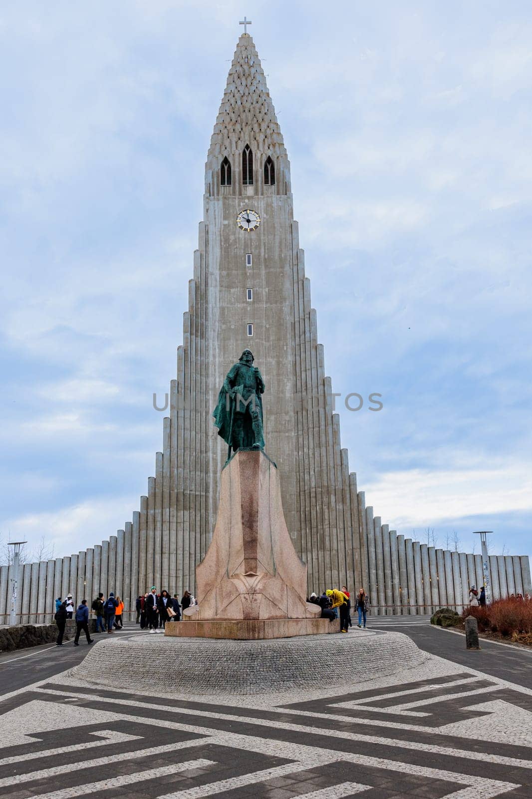 Hallgrimskirkja cathedral circa March 2023 with majestic concrete statue of explorer Leif Erikson, holy sacred monument. Spectacular tall building indicating lutheran faith and religion.