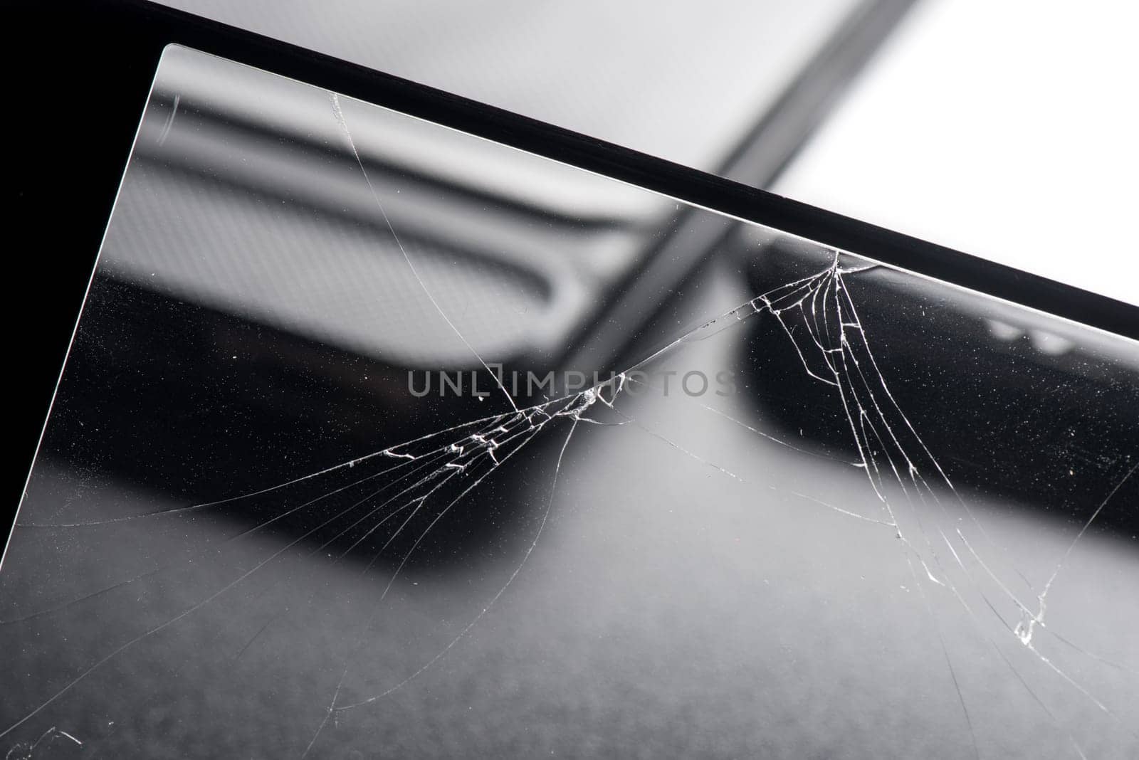 closeup broken tempered glass screen protector for smartphone.