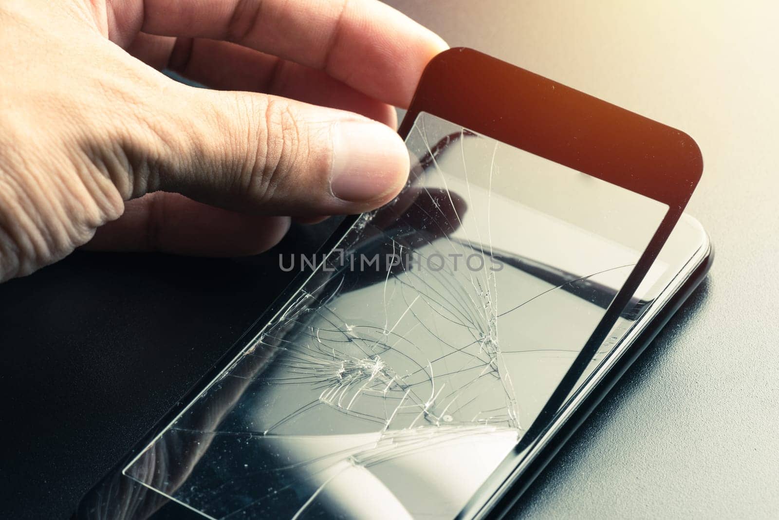 closeup broken tempered glass screen protector for smartphone.