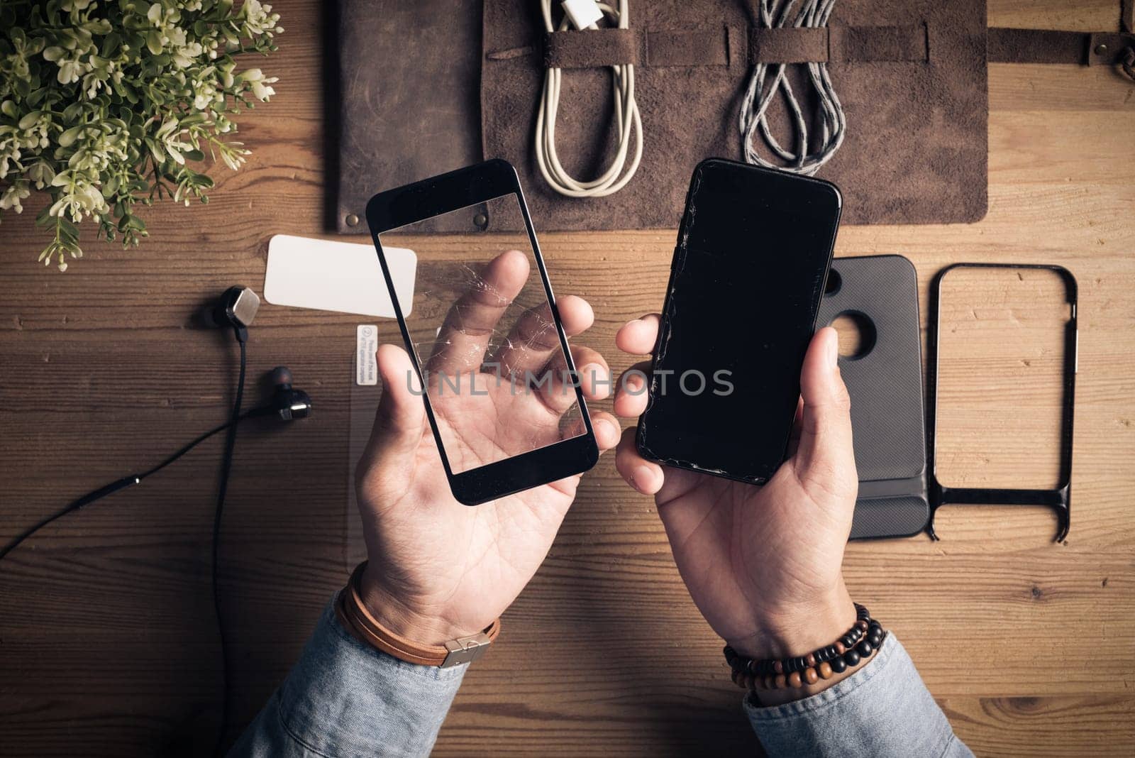 The man replacing the broken tempered glass screen protector for smartphone.