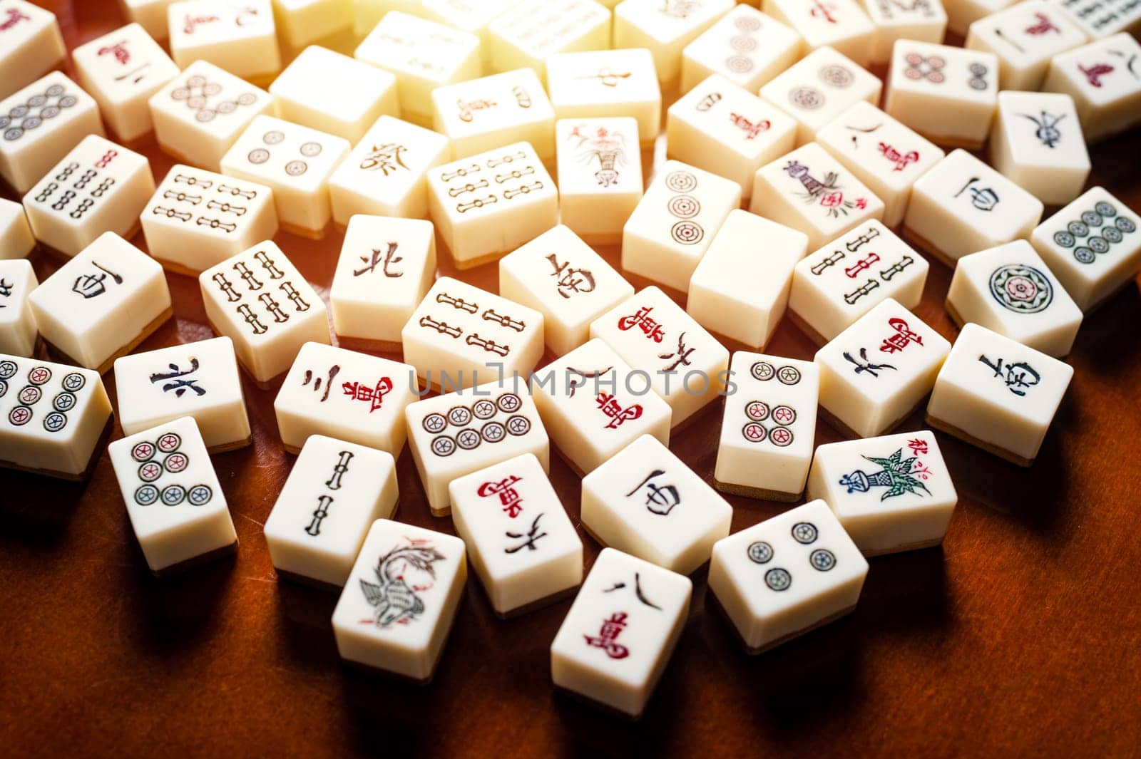 Many old mahjong tiles on wooden table. Mahjong is the ancient asian board game.