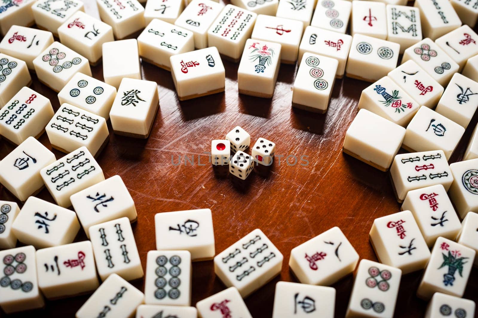 Many old mahjong tiles on wooden table. Mahjong is the ancient asian board game.