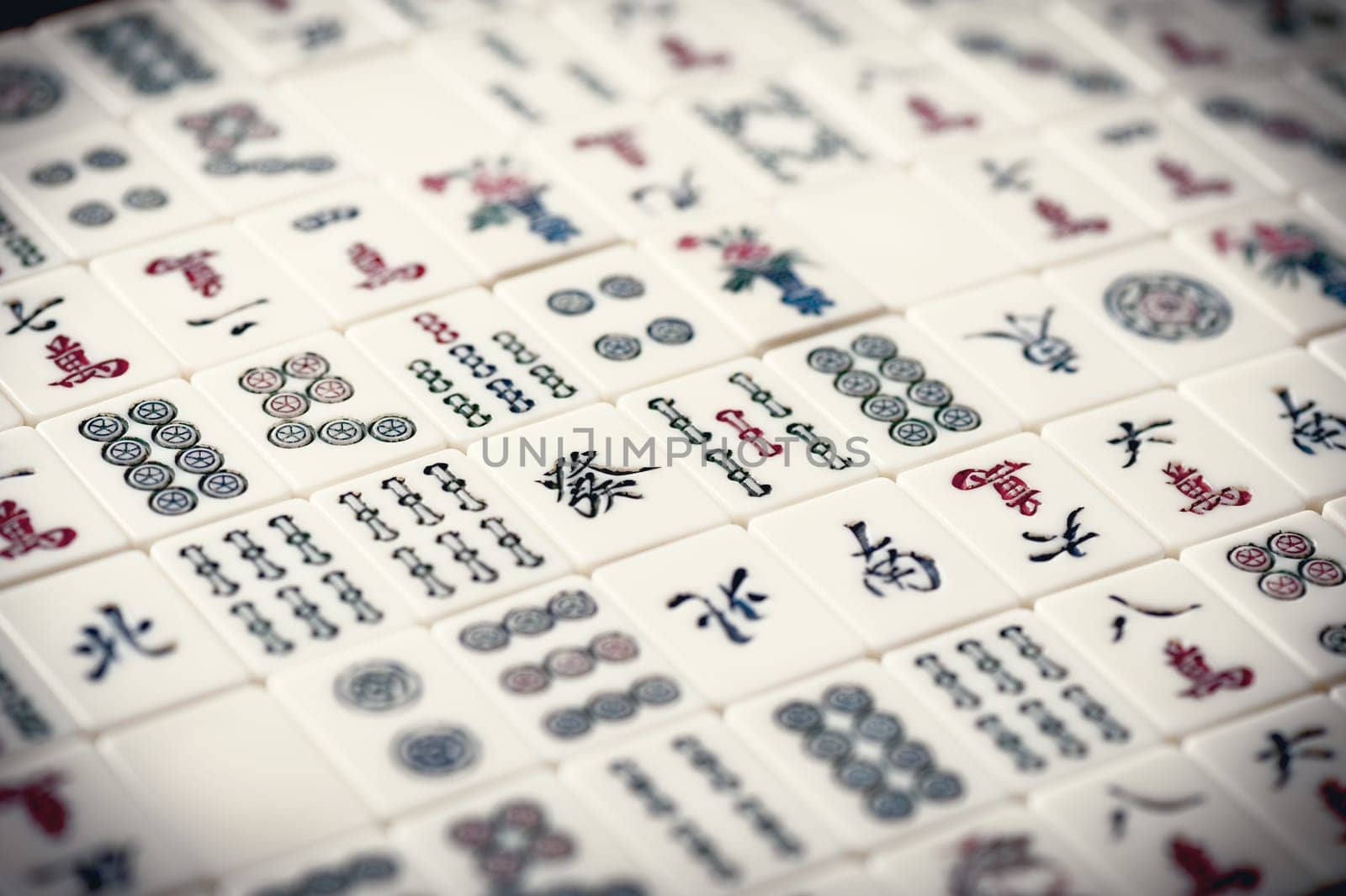 Many old mahjong tiles on wooden table. Mahjong is the ancient asian board game.