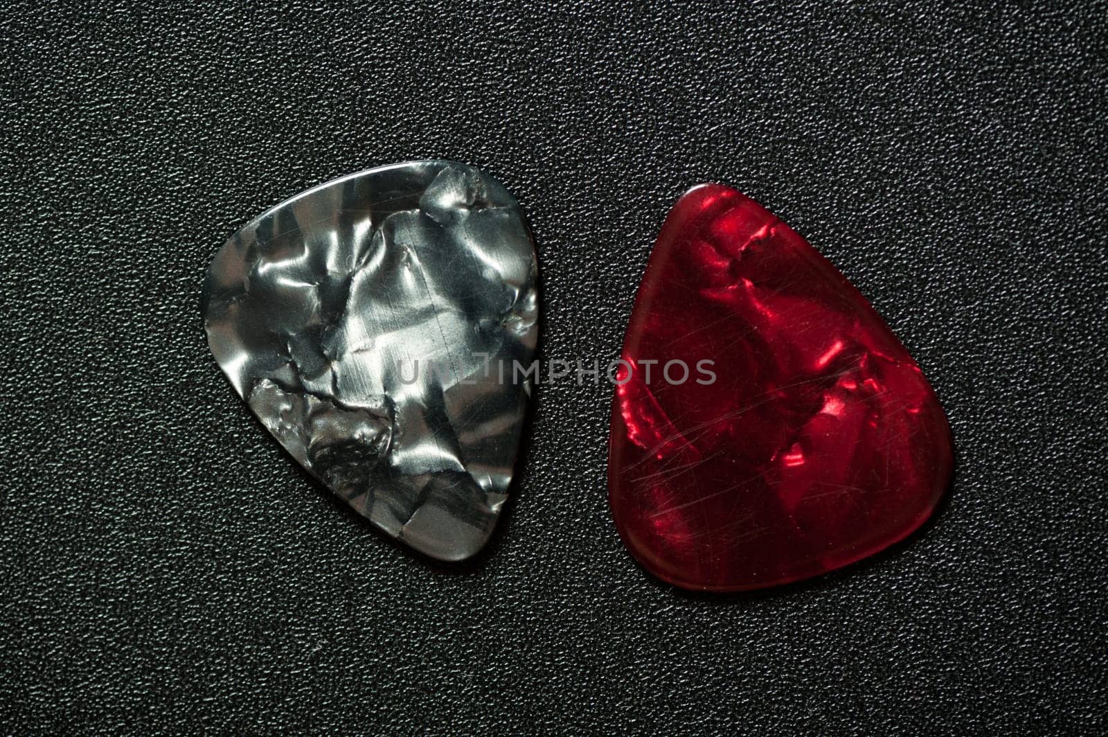 Closeup guitar pick on black background. A guitar pick is a plectrum used for guitars.