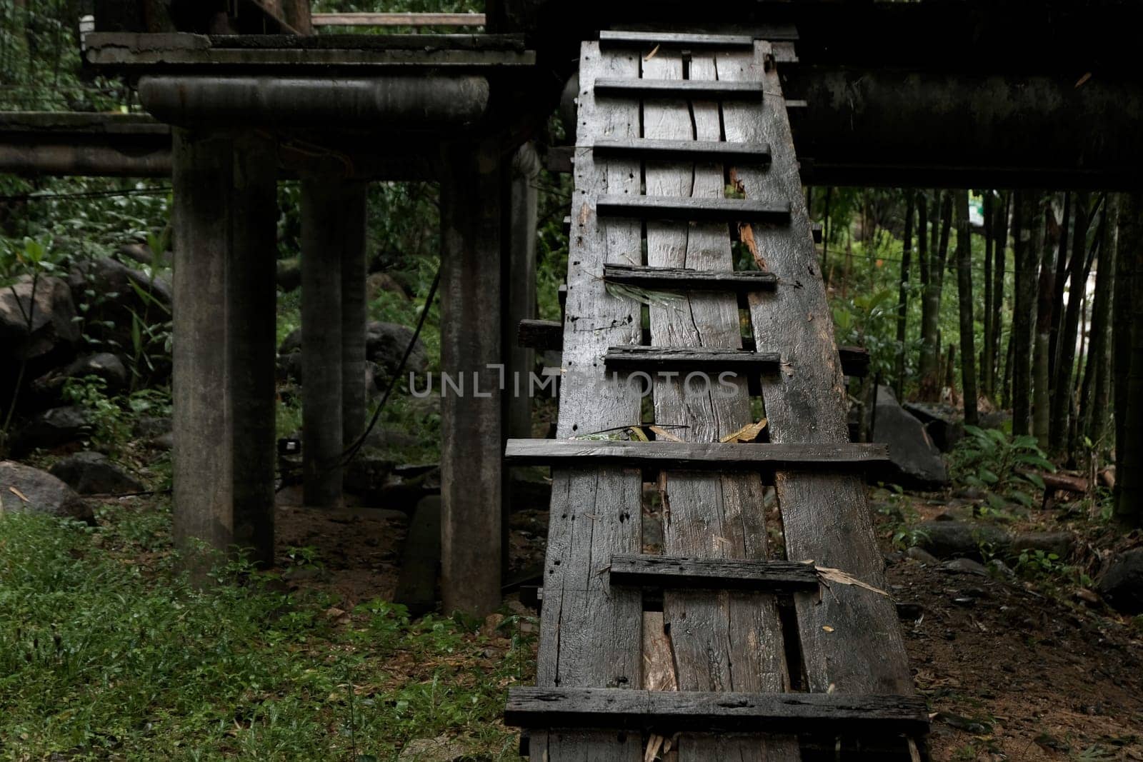 old wet rustic wooden steps in low light