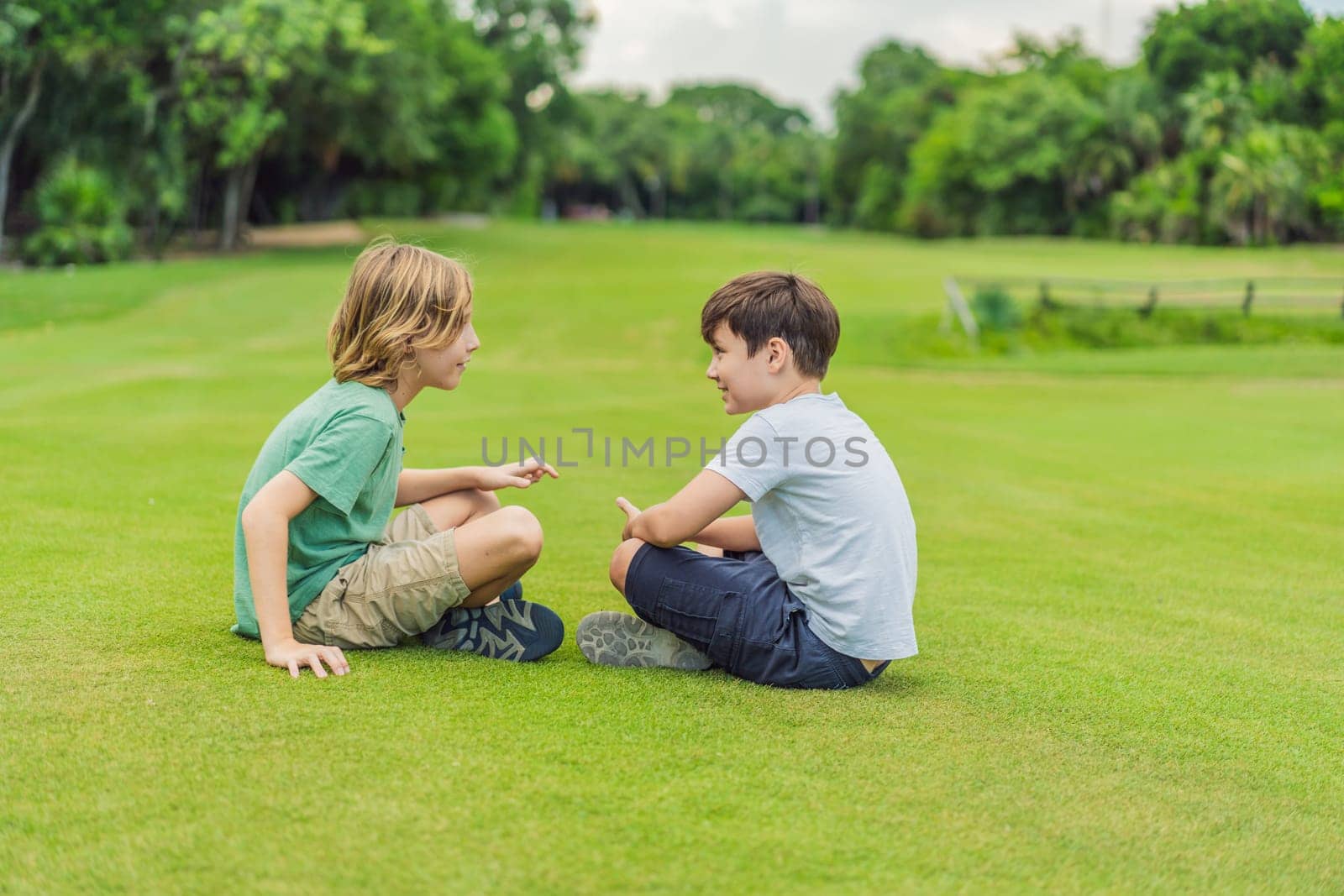 Two young boys share laughter and adventures in the sunlit park, cherishing the bonds of friendship and carefree moments.