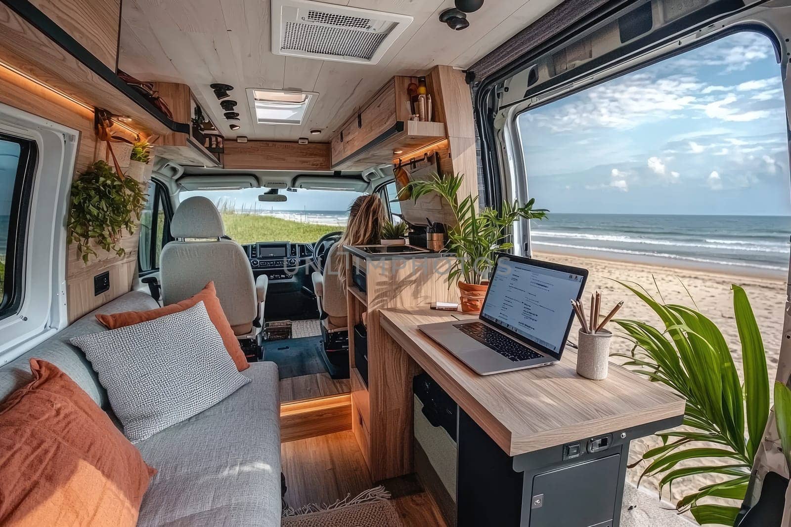 Experience the blend of comfort and adventure in a stylish van interior with a beach view, perfect for remote work and rejuvenation amidst nature.