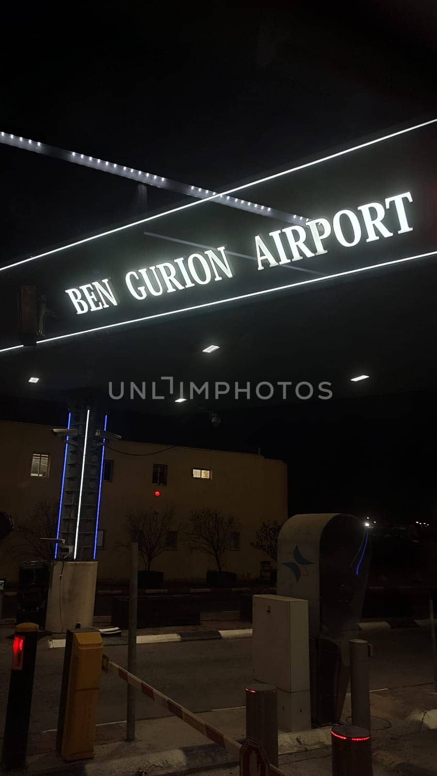 15 October 2024 Tel-Aviv Israel Ben Gurion airport, white lamp text sign at night at the entrance. High quality photo