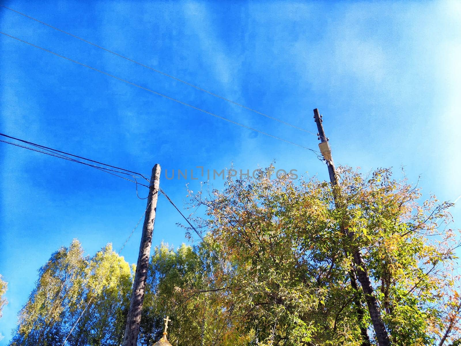 Old pole with wires against the sky. Electric transmission line, Eco-friendly energy