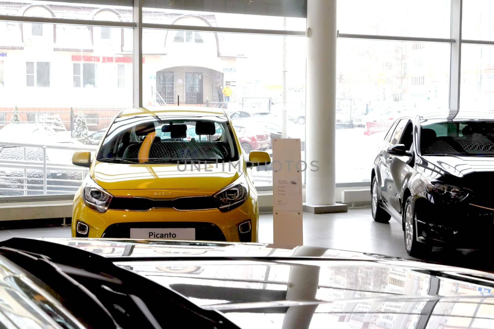 Kazan, Russia - November 25, 2022: Cars in showroom of dealership Kia in Kazan in Russia. Partial focus