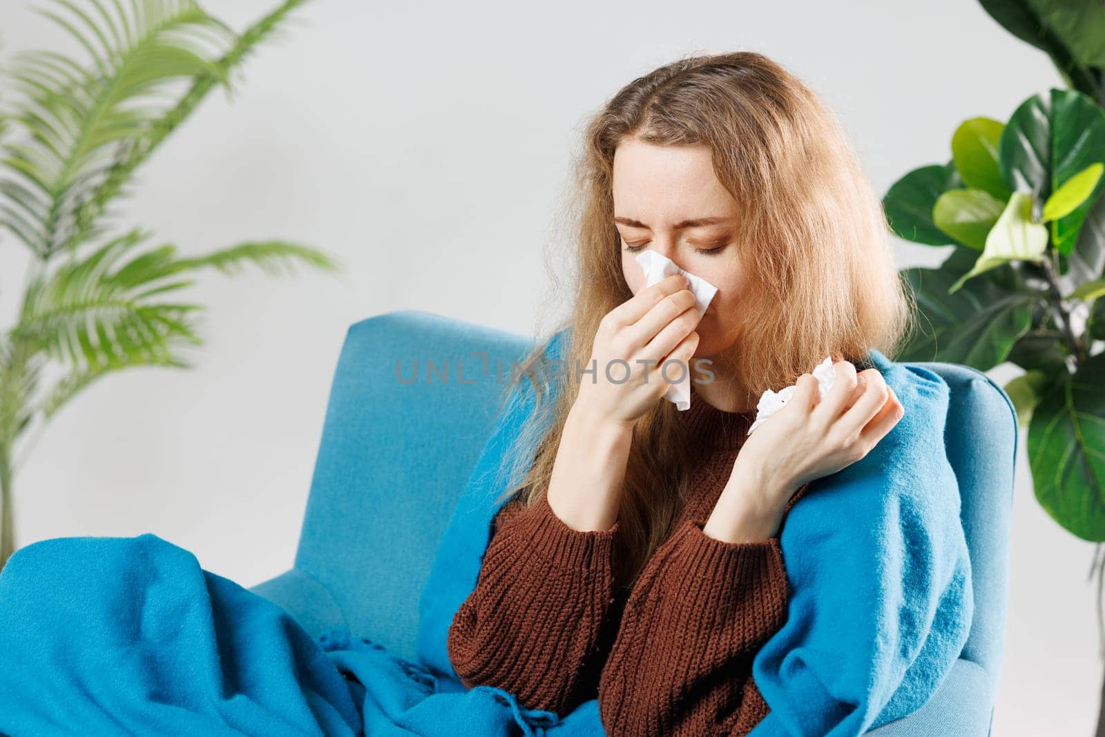 Sick, influenza young woman, girl headache have fever, hand touching forehead, holding thermometer for check measure body temperature, illness while sitting rest on sofa at home. Health care