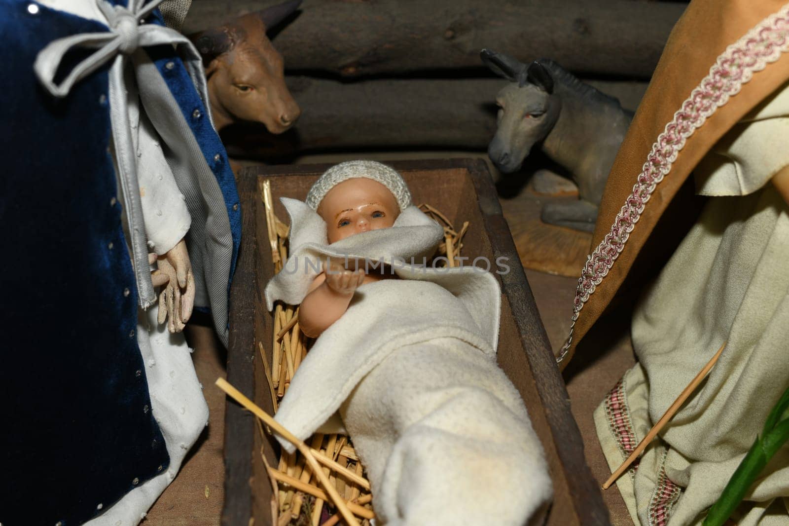 Baby Jesus laying in a cradle Christmas Creche
