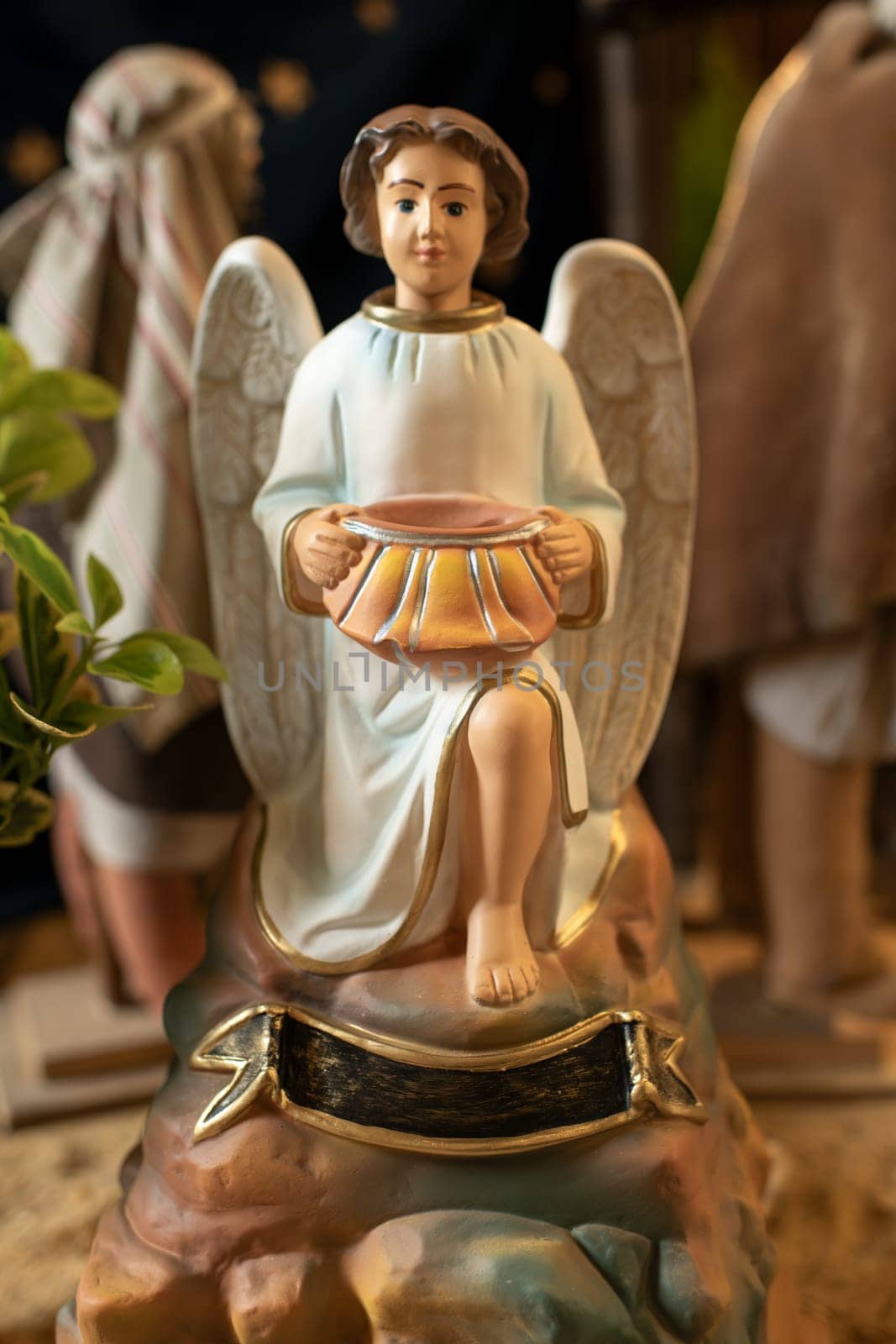 Angel with wings holds a pot in his hands Scene of the birth of Jesus Christ