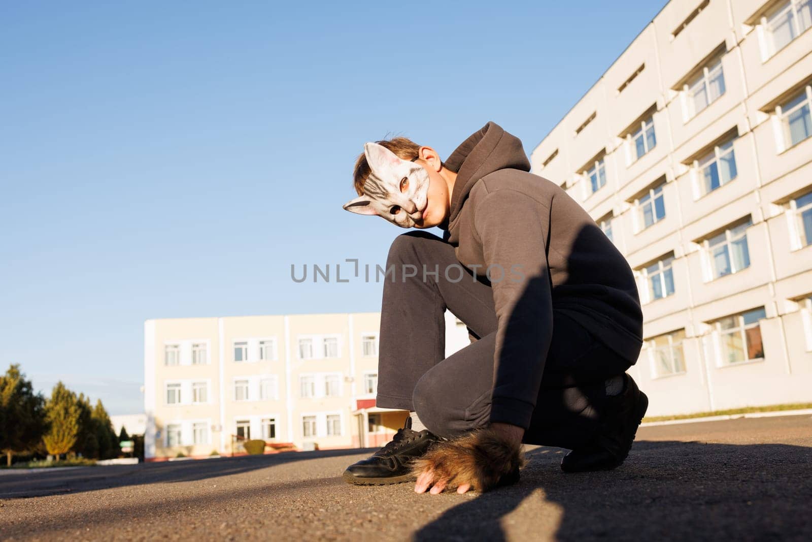 boy quadrober in cat mask sit in city, quadrober children, subculture