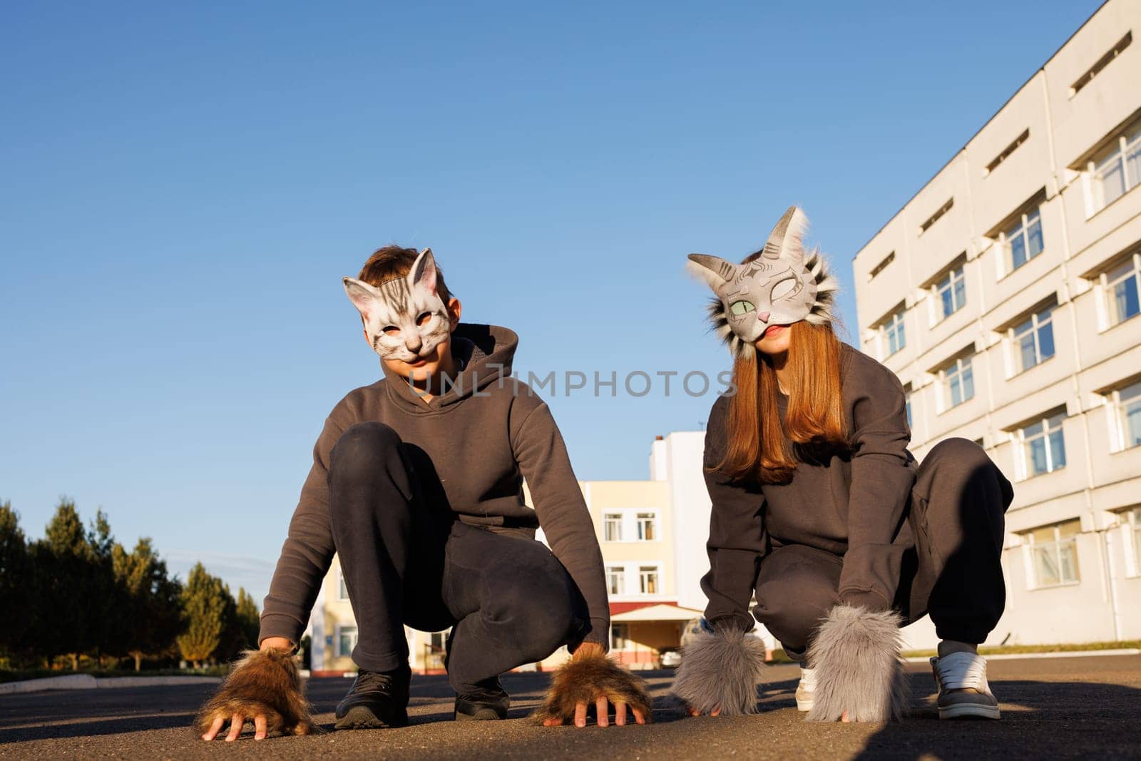 Girl and boy quadrober in cat mask sit in city, quadrober children, subculture