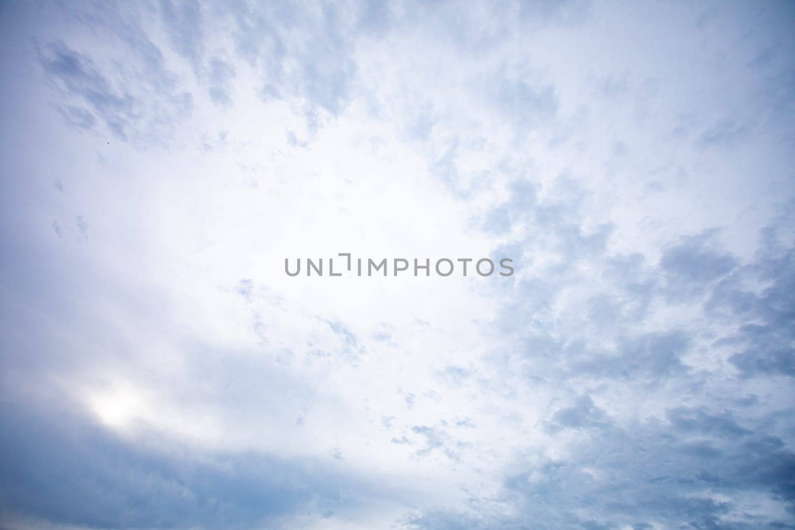 An ethereal view of a soft, gently cloudy sky creating a beautifully serene atmosphere during the dusk period