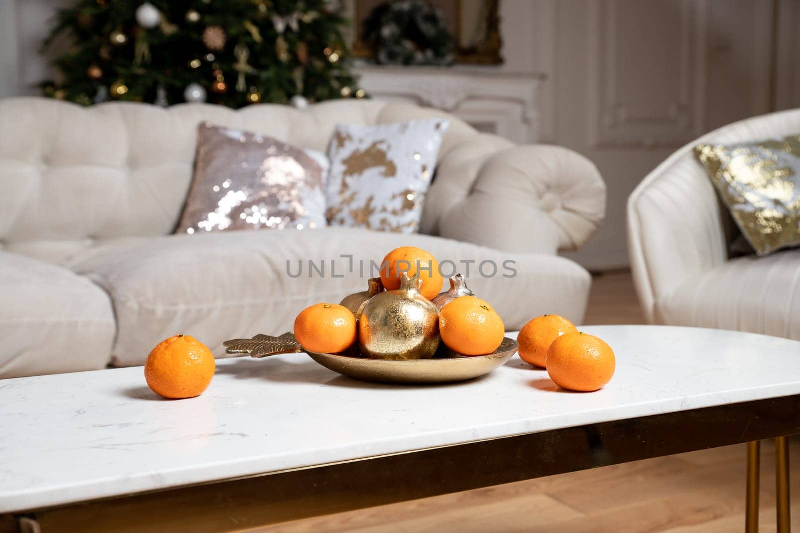Winter still life . cotton and tangerines on a wooden table. Cotton in white vase. White wall, wooden table.