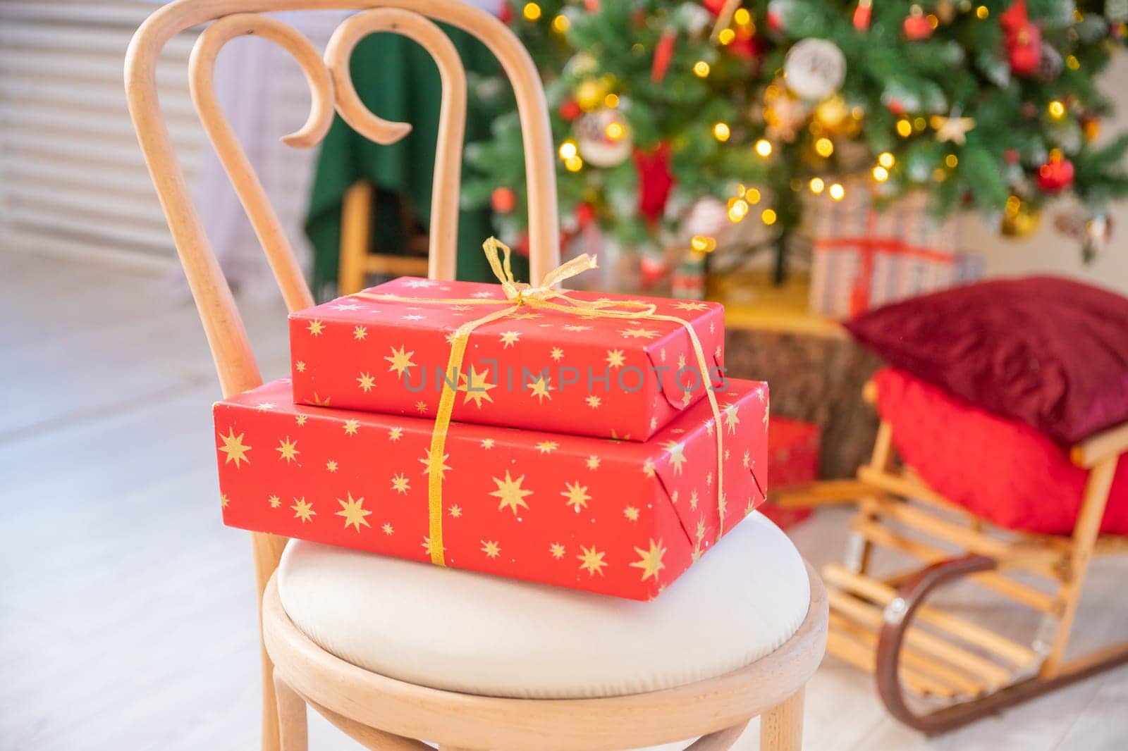 christmas tree with gift boxes.Warm living room decorated with Christmas accessories.