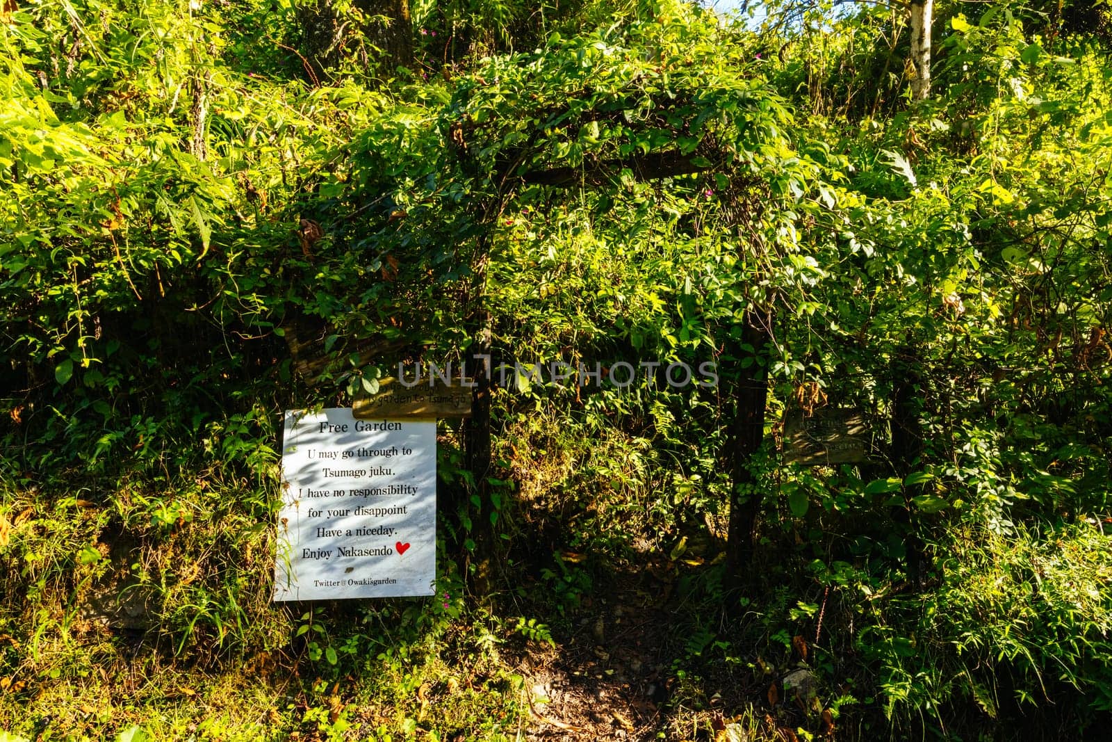 Hiking path garden on the famous Magome-Tsumago Trail as part of the Nakasendo Way between Magome and Tsumago in Gifu Prefecture, Japan