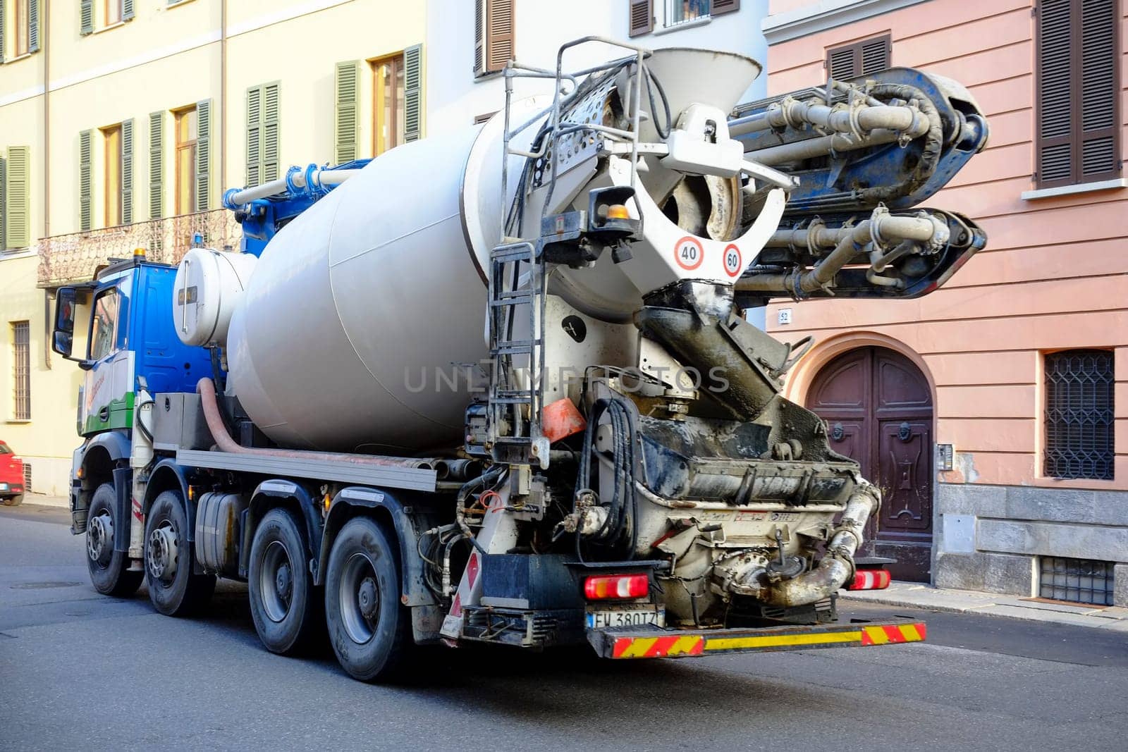 Cremona, Lombardy, Italy - November 7th 2024 Cement mixer truck transporting concrete on a city street, ensuring timely delivery for construction projects