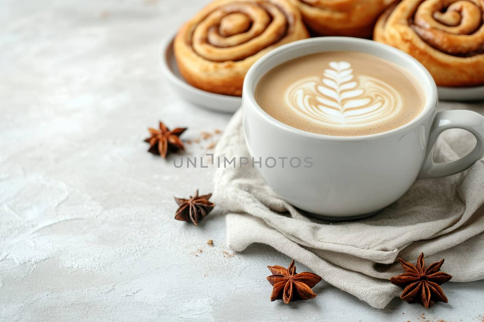 Freshly baked cinnamon buns on linen napkin with hot coffee , traditional swedish sweet pastry kanelbulle..