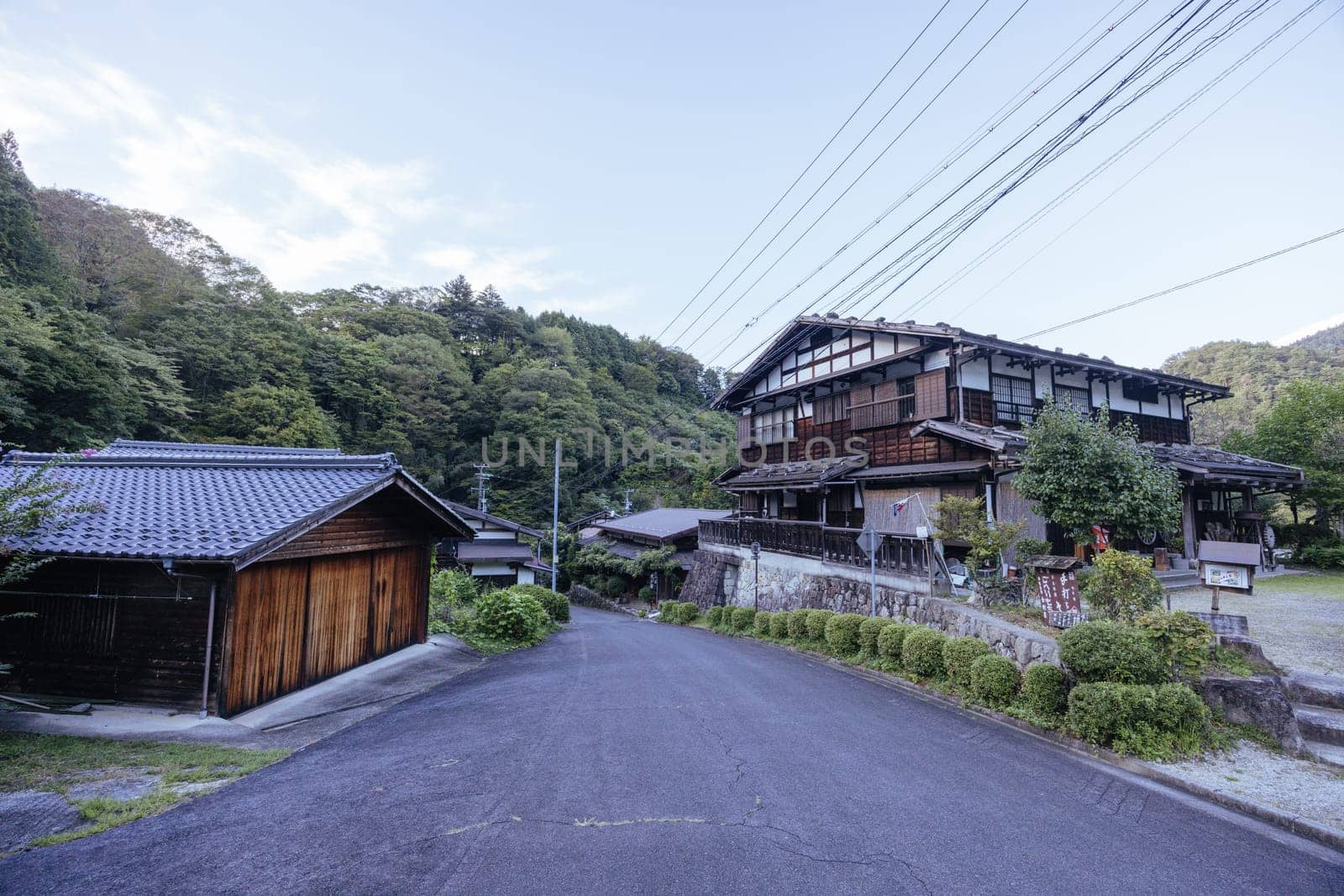 Hiking path and towns on the famous Magome-Tsumago Trail as part of the Nakasendo Way between Magome and Tsumago in Gifu Prefecture, Japan