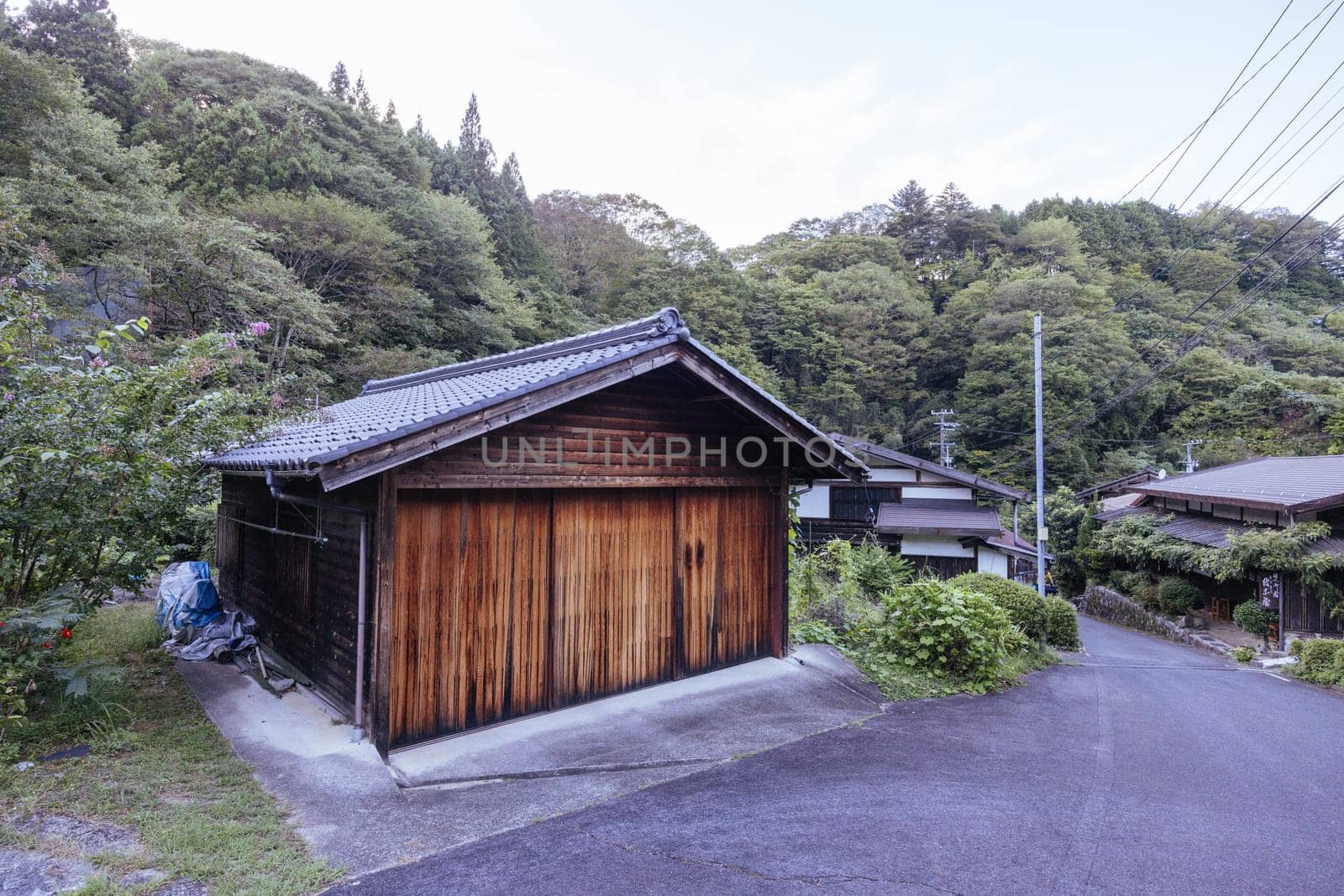 Hiking path and towns on the famous Magome-Tsumago Trail as part of the Nakasendo Way between Magome and Tsumago in Gifu Prefecture, Japan