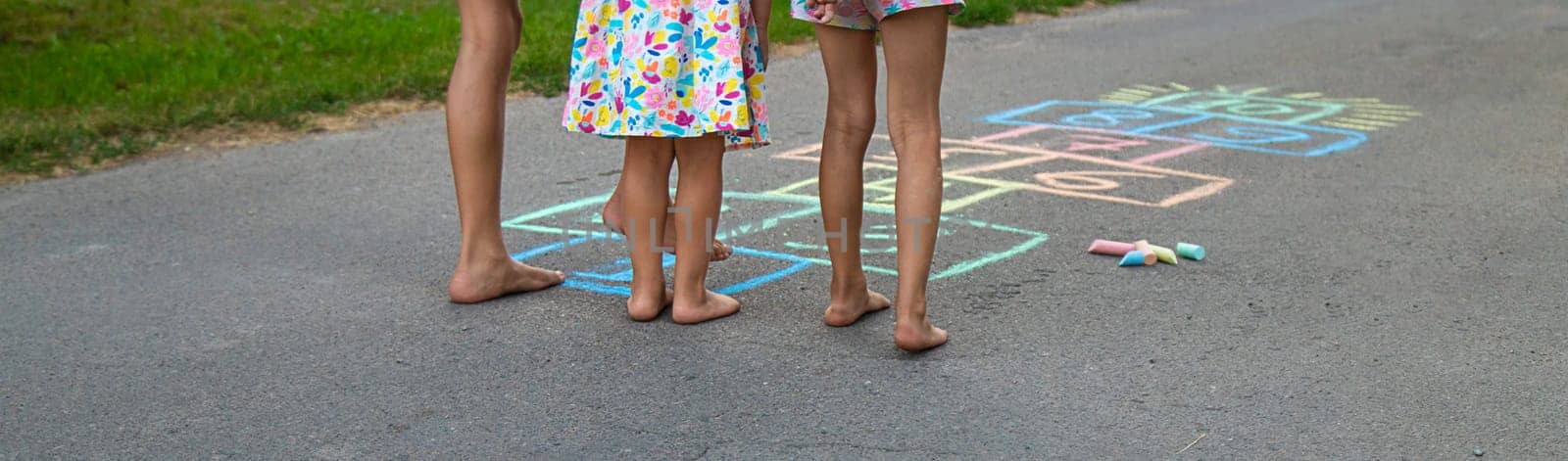 Children jumping hopscotch on the street. Selective focus. kids.