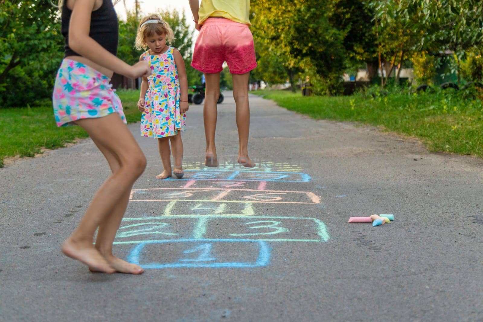 Children jumping hopscotch on the street. Selective focus. kids.