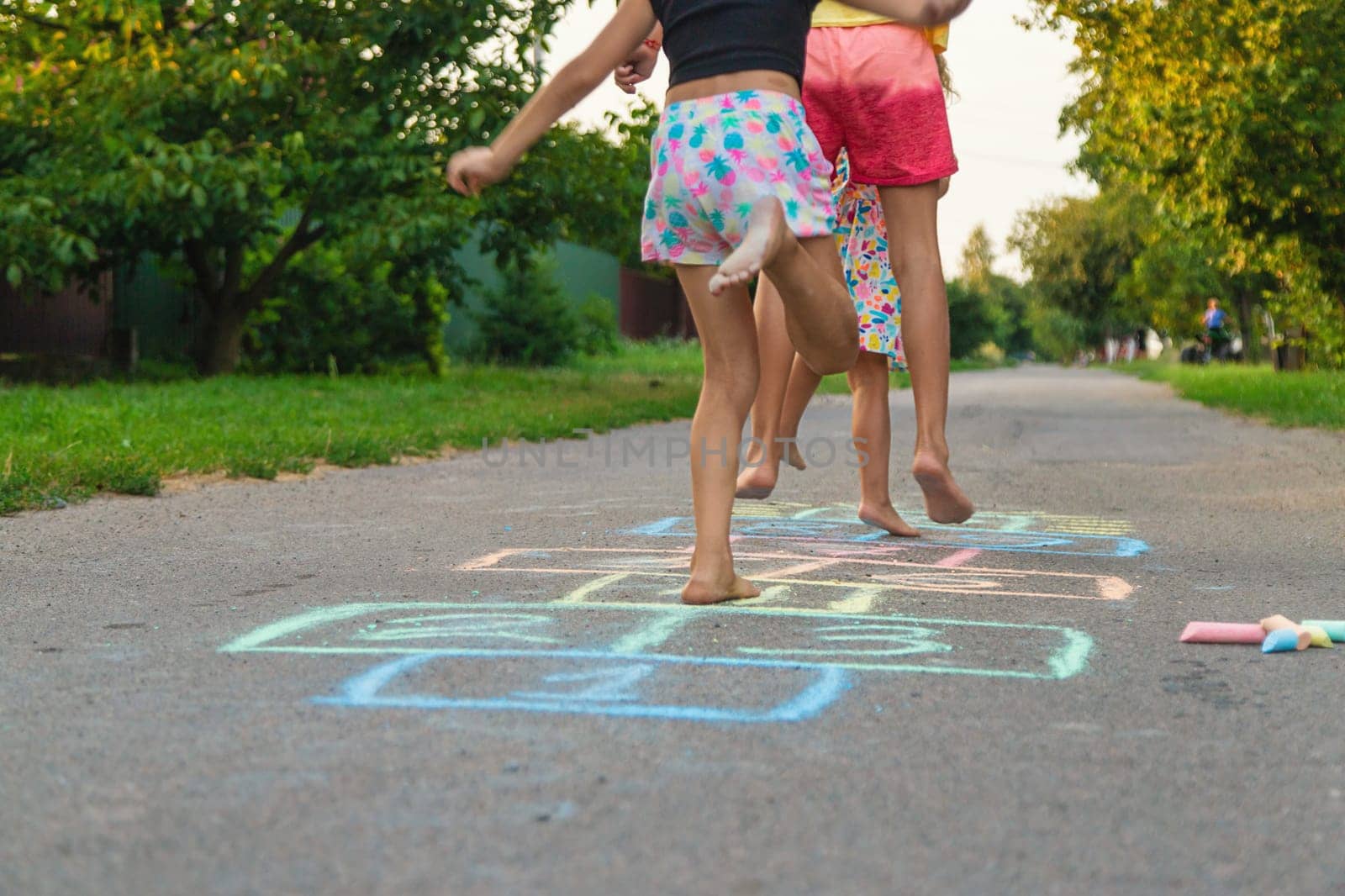Children jumping hopscotch on the street. Selective focus. kids.