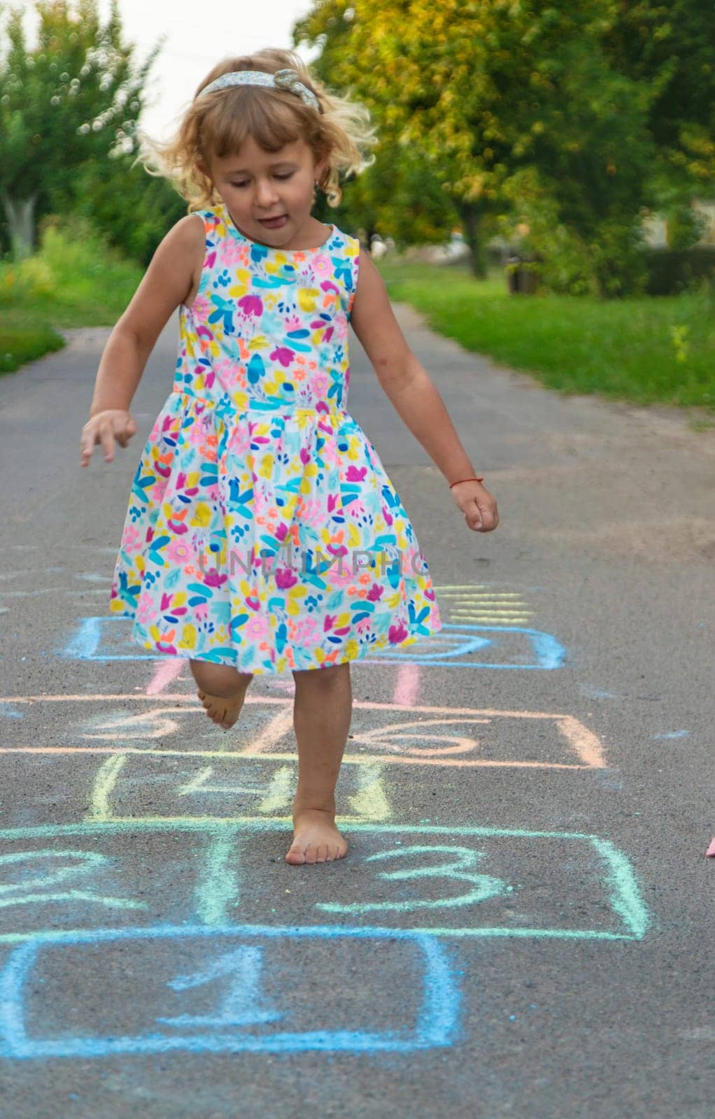 Children jumping hopscotch on the street. Selective focus. kids.