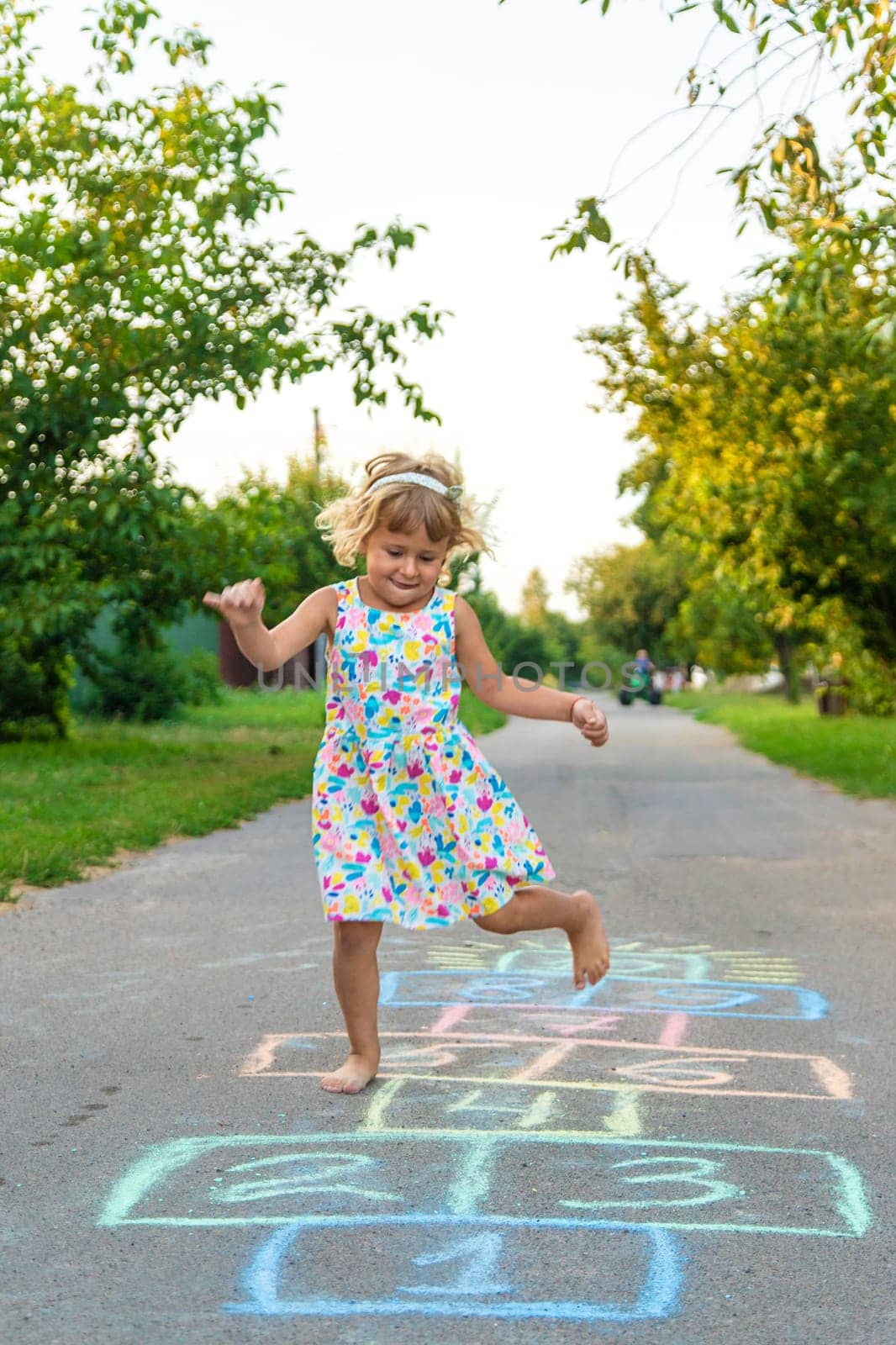 Children jumping hopscotch on the street. Selective focus. kids.