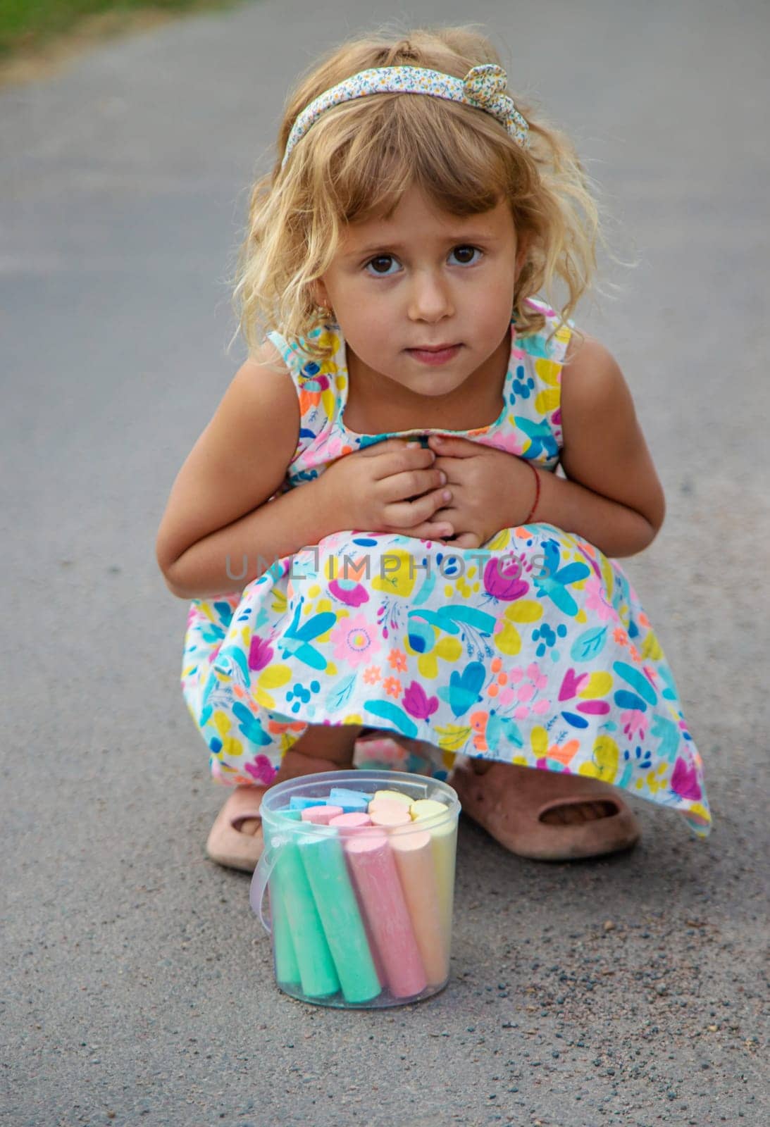 Children draw with chalk on the asphalt. Selective focus. kid.